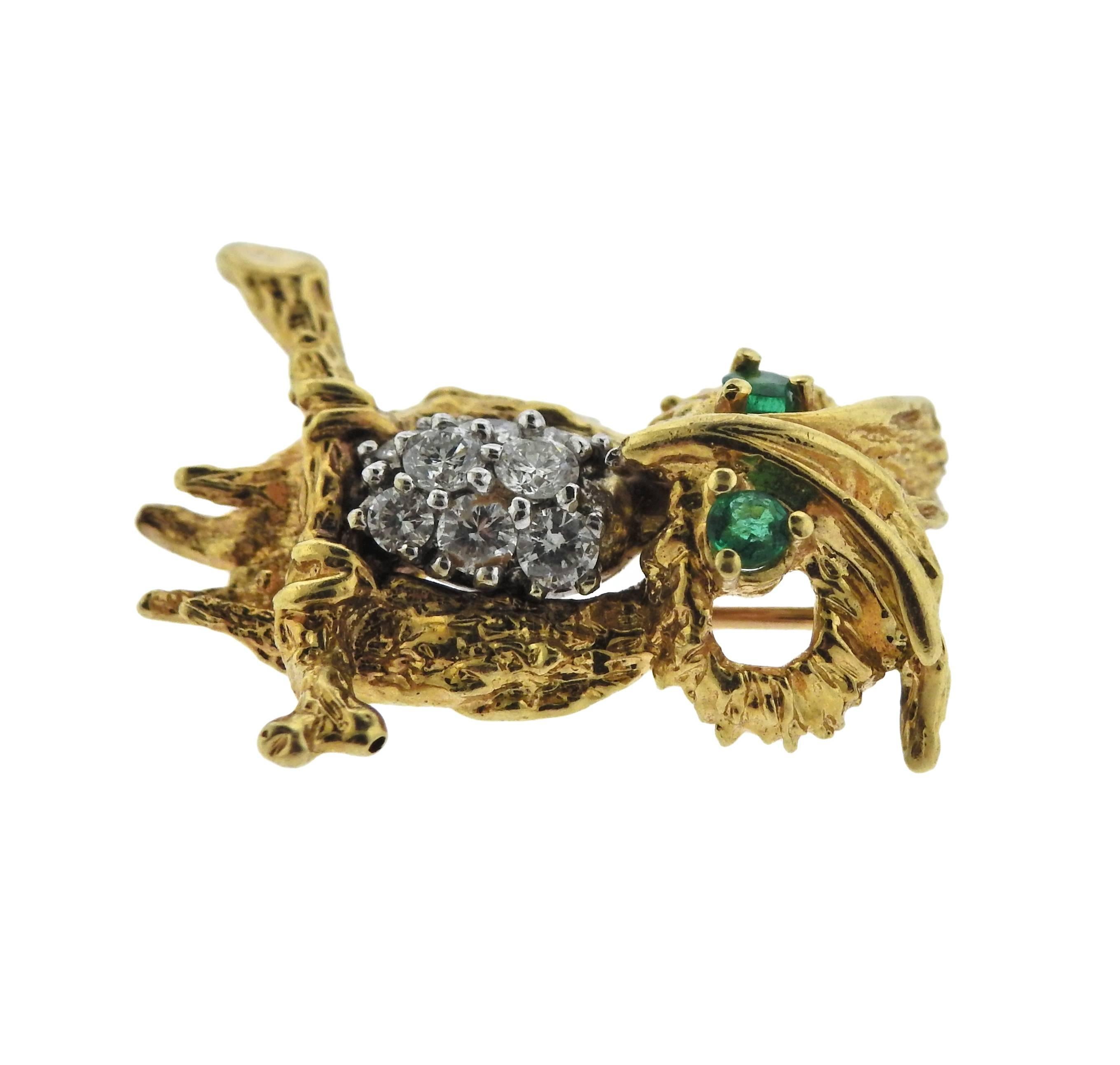 18k gold owl brooch from the 1960's, featuring approximately 0.40ctw of G-H/SI1 diamonds, and emerald eyes. Brooch measures 25mm x 23mm and weighs 6.8 grams. 