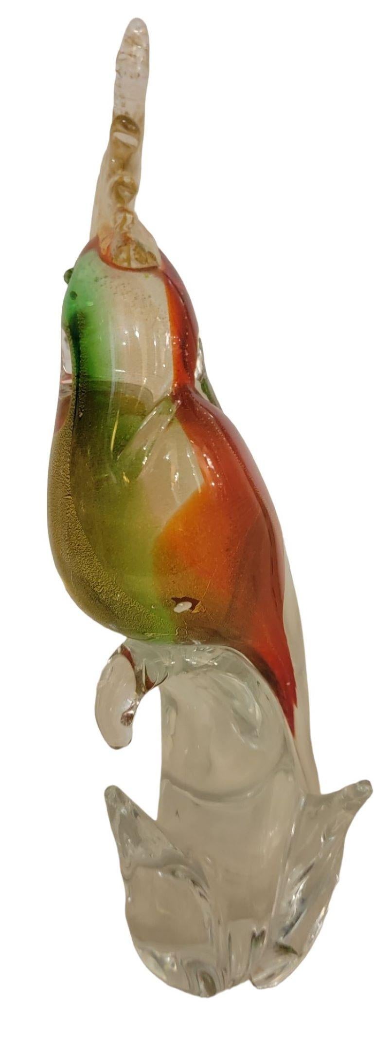 Gold Fleck Venezia Murano Parrot with beautiful red, green and yellow glass that are hand blown and very well proportioned to an actual bird. The glass is stunning with gold fleck within the glass.

Measures 12h x 4w.