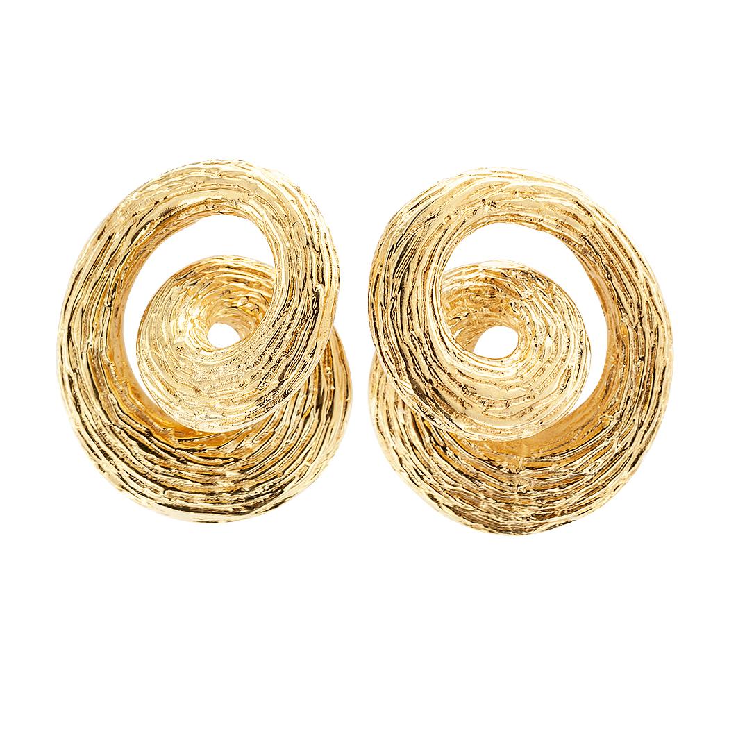 1960s gold knot ear clips. The matching designs resemble a circle that loops and curls on itself; thereby giving the impression of a knot, crated in 14-karat yellow gold finished with a bark like texture that is neither matte nor shiny. We love that
