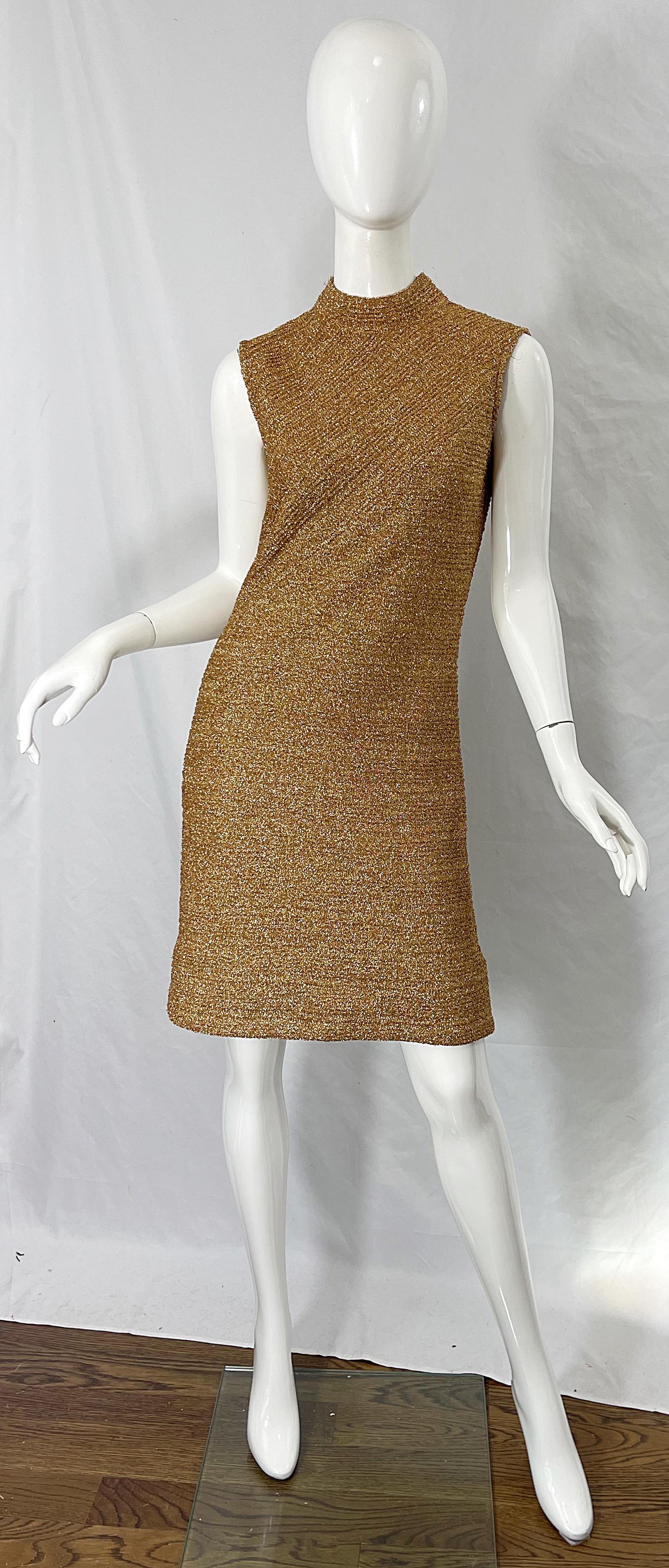 Chic 1960s CABOT gold metallic sleeveless shift dress ! Features a high neck with tailored bodice. 100% metallic yarn offers plenty of stretch. Hidden metal zipper up the back with hook-and-eye closure. 
Perfect for any day or evening event. Pair