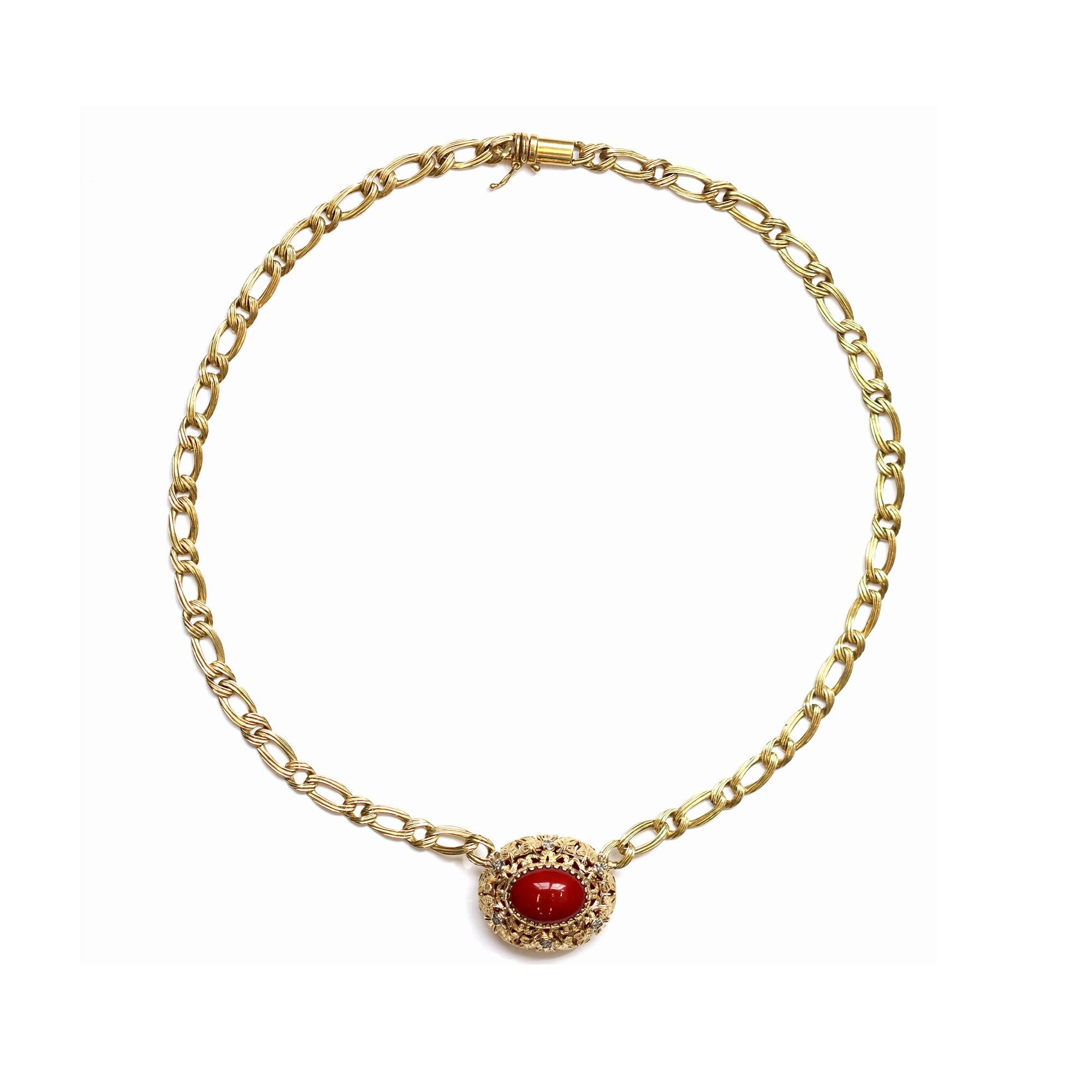 A necklace circa 1960 featuring an Oxblood coral Cabochon with an intricate handmade bezel. The Coral is natural with no indications of enhancement or dye and displays a very dark brownish-red hue. The necklace is set in 18-karat yellow gold. The
