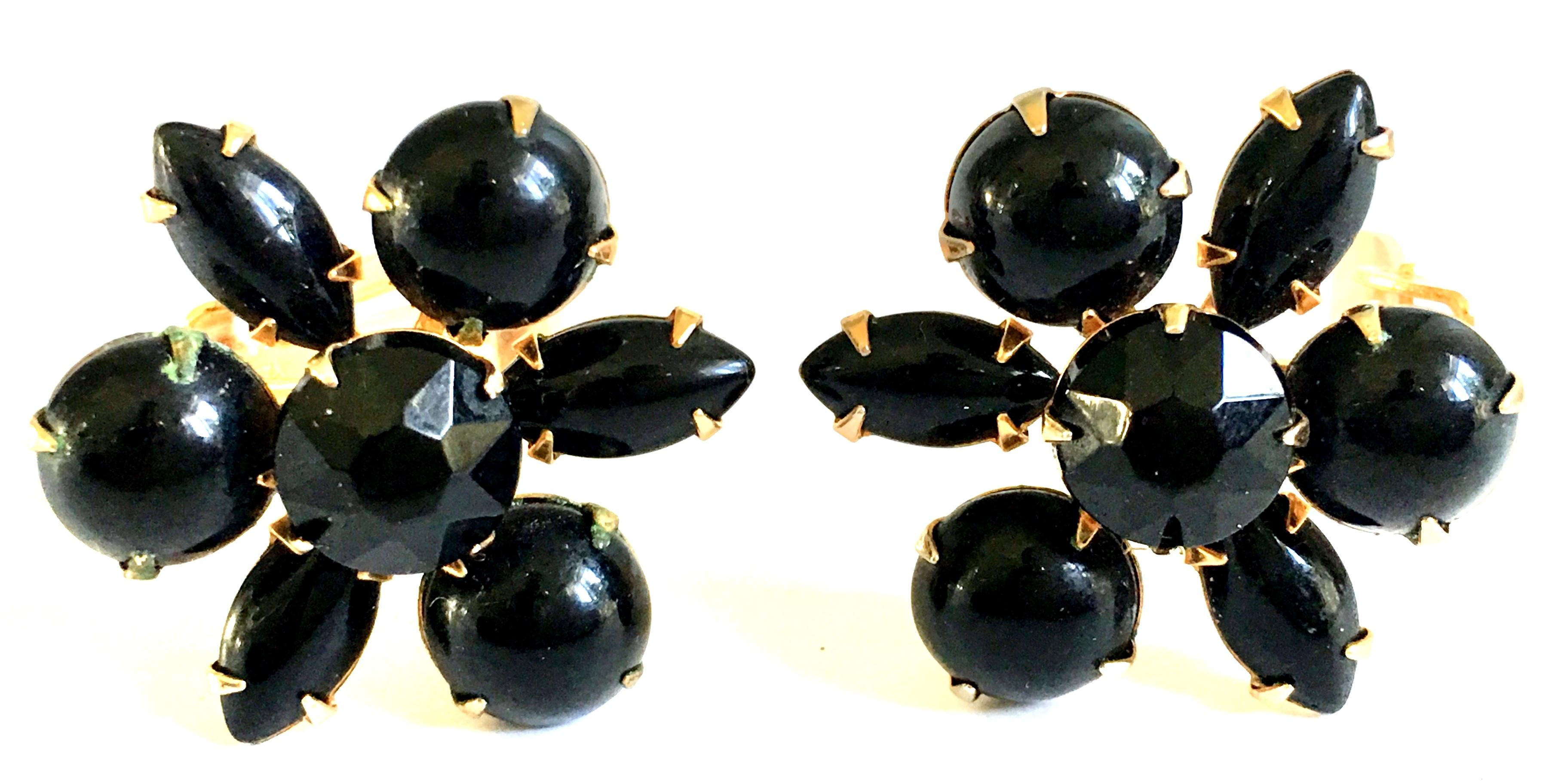 1960'S Gold Plate & Molded Glass Abstract Dimensional Flower Earrings. These clip style earrings feature, prong set black polished cut and faceted molded glass stones. 