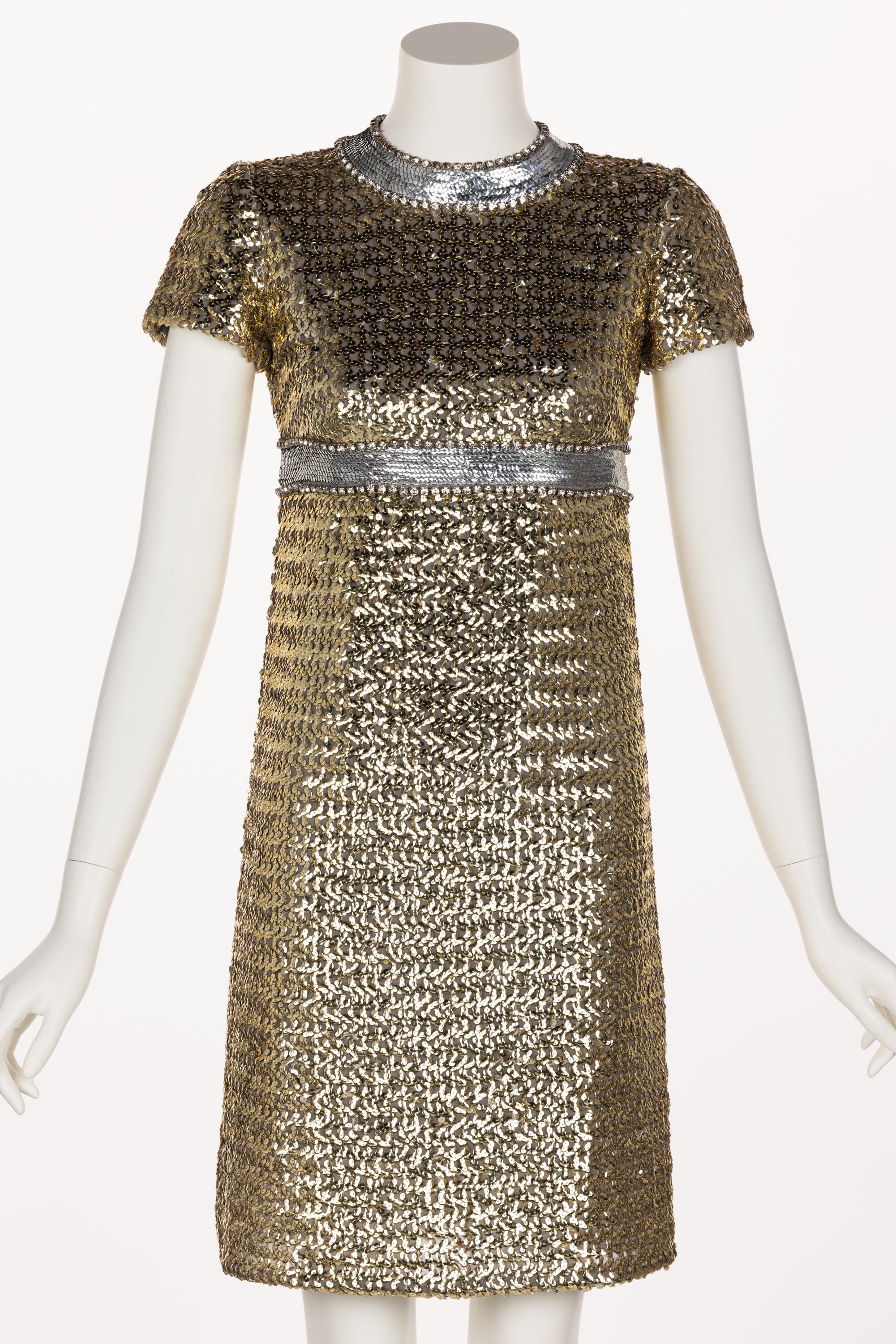 The designer of this dress is unknown, but that makes it no less spectacular. Possibly created by renowned Italian-French designer Pierre A. Cardin, this 1960’s dress is an incredible statement piece. Done in gold and silver sequins with prong-set