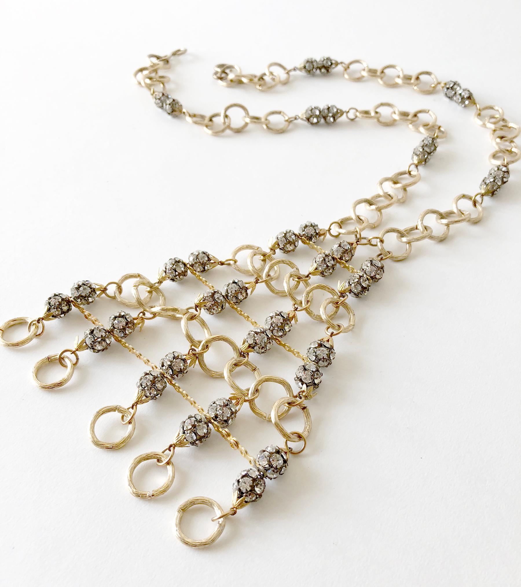 Gold toned aluminum and rhinestone glam statement necklace, circa 1960's. Necklace measures 22
