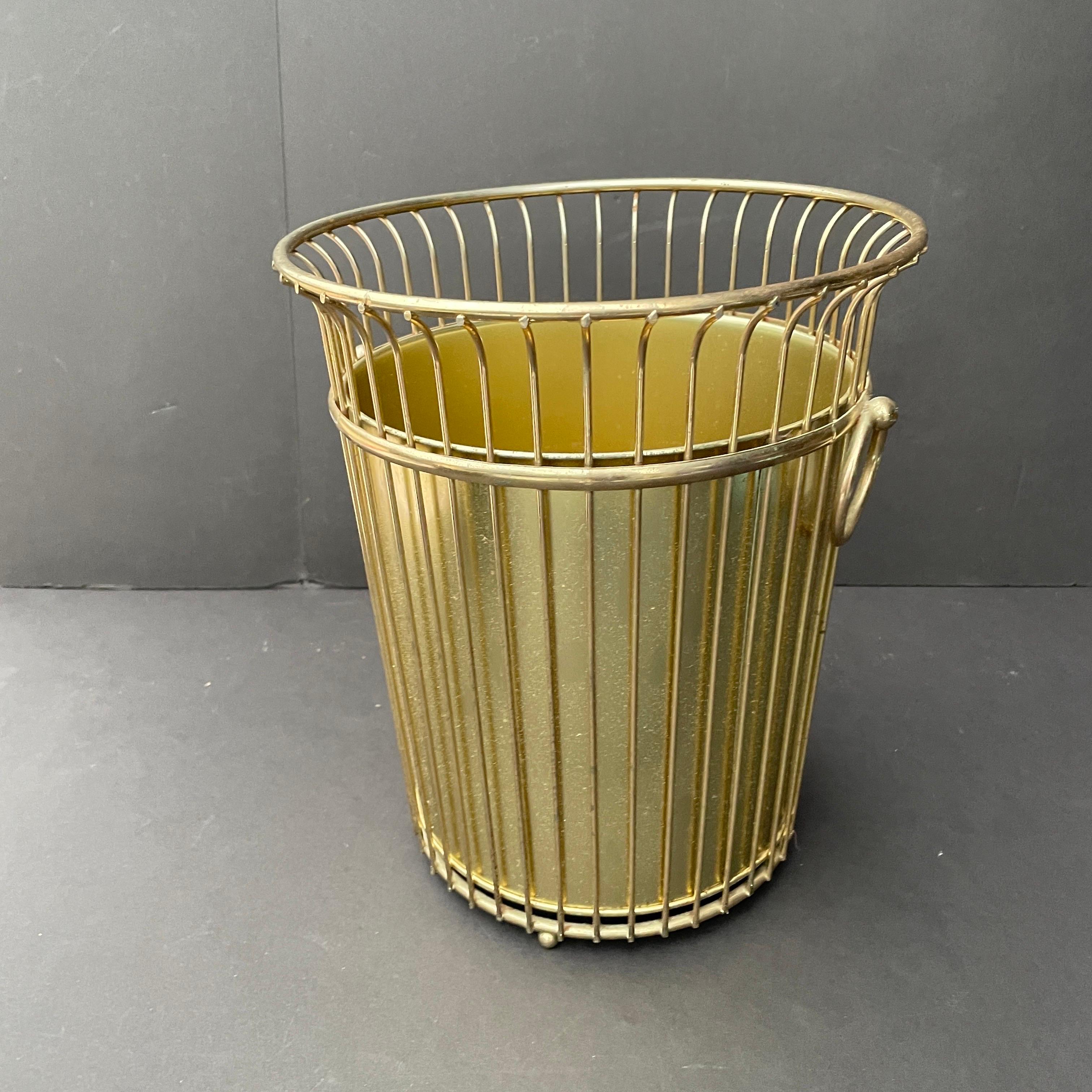 Vintage 1960s Hollywood Regency metal wastebasket with liner. The outside wired portion is in good condition, with little to no wear. There are a few small rust spots on the inner base of the liner. No makers mark. 