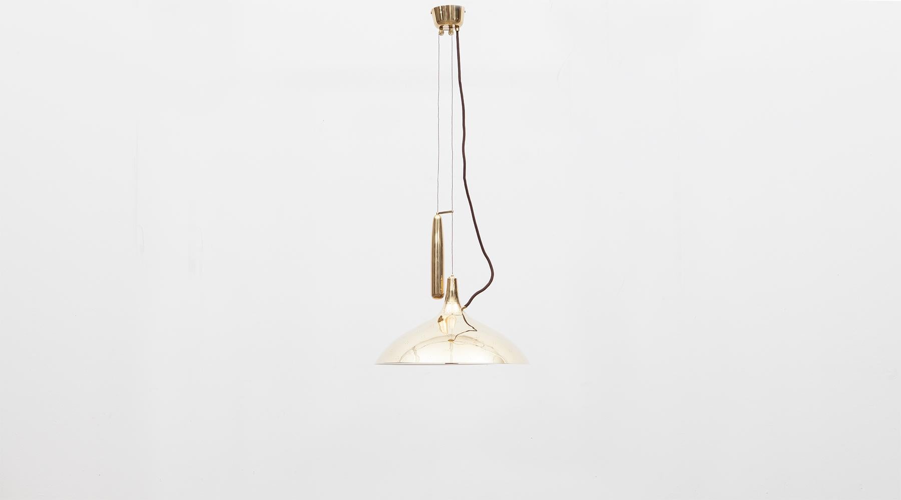 Brass and etched glass, ceiling lamp by Paavo Tynell, Finland, 1965.

Very elegant brass counterweight pendant designed by famous Finnish Paavo Tynell. Tapered with an etched glas cover, giving a warm charming light. A large brass weight allows to