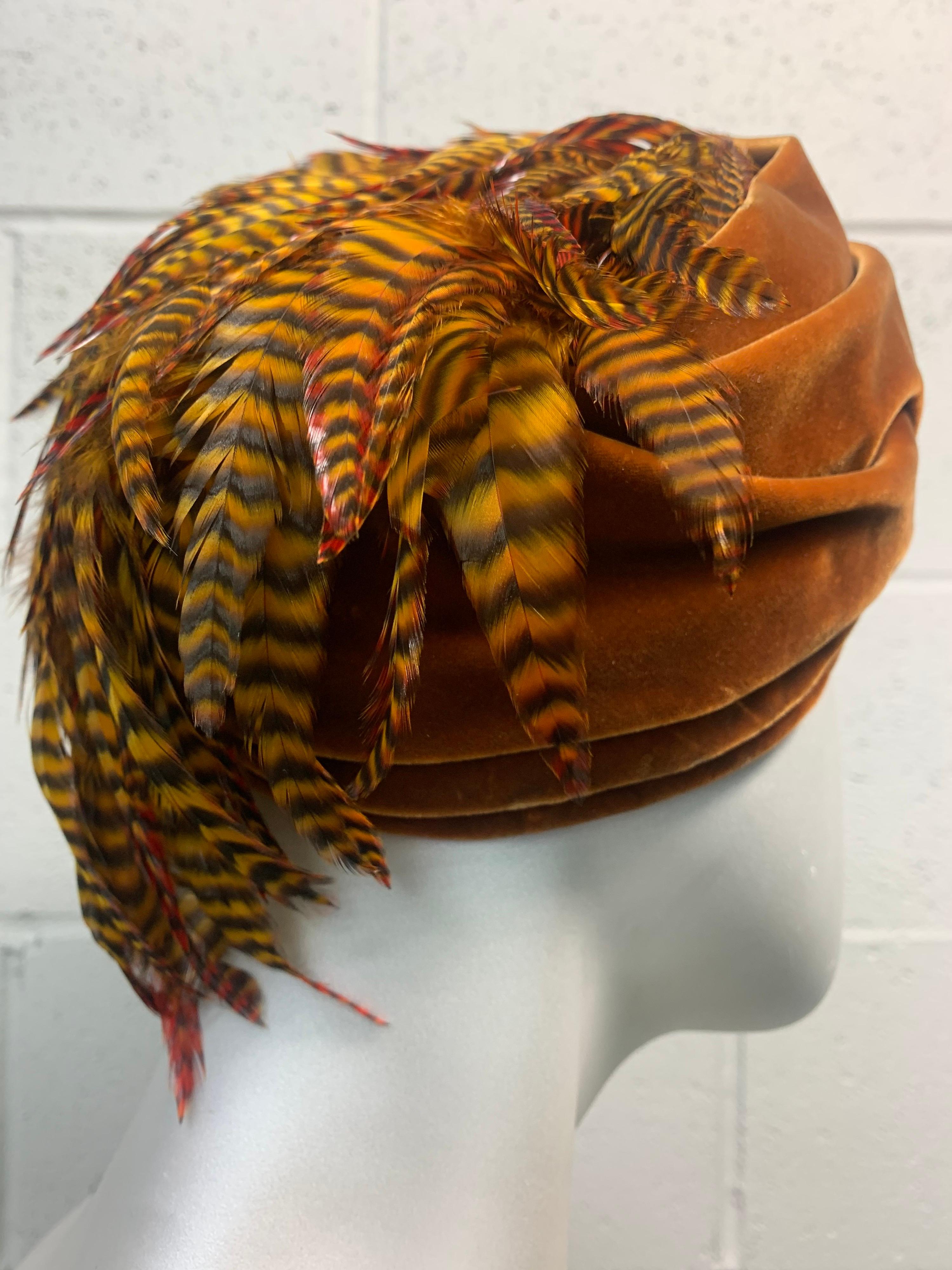 A wonderful Gottlieb 1960s golden caramel velvet turban hat with a stunning cascade of gold-tinted pheasant feathers at back. Medium size. 