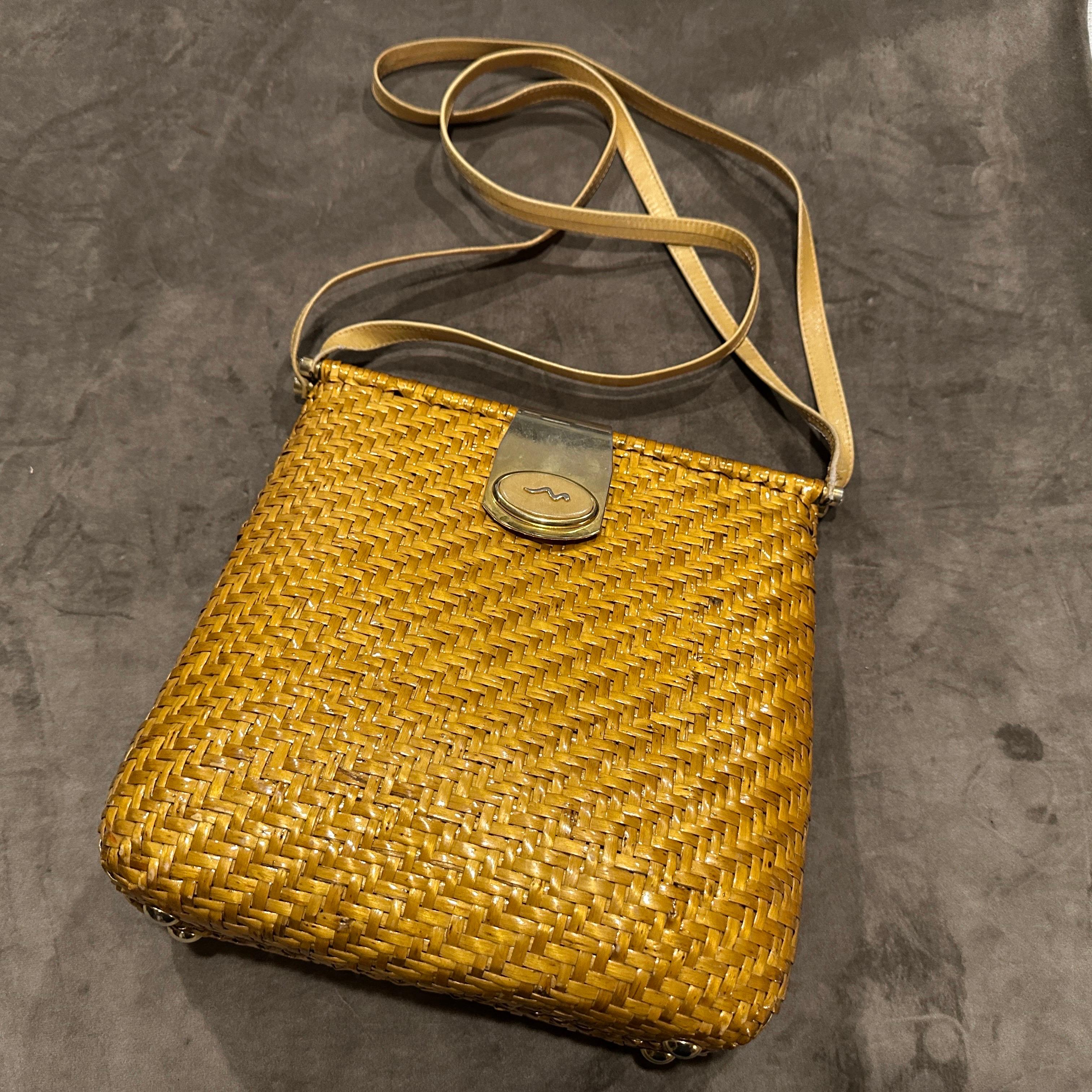 This charming Italian vintage shoulder bag is a sun-kissed example of timeless craftsmanship, blending natural texture with refined details.  Made from golden-toned wicker, woven in a diagonal pattern that adds both visual interest and structural