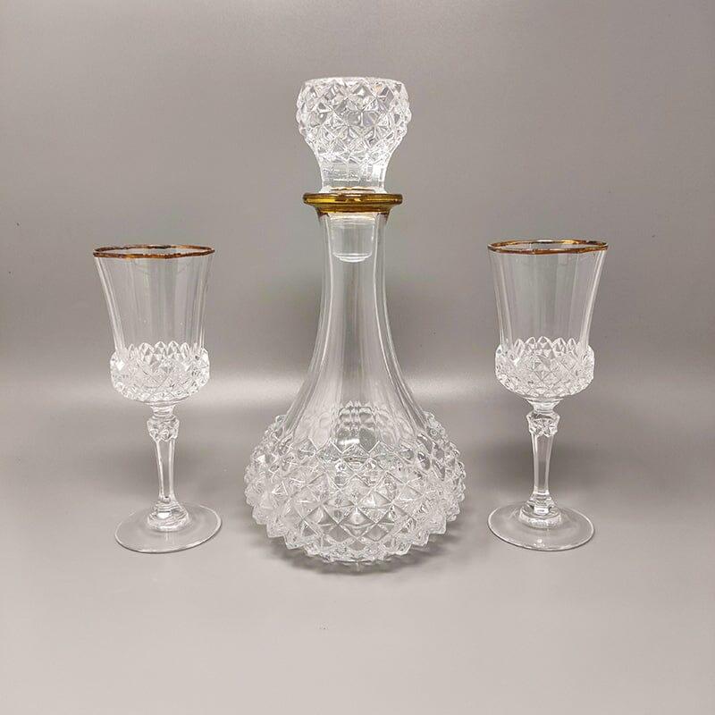 1960s Gorgeous crystal decanter with 2 crystal glasses. Made In Italy The items are in excellent condition. 
Dimension:
Decanter
diam 5,51
