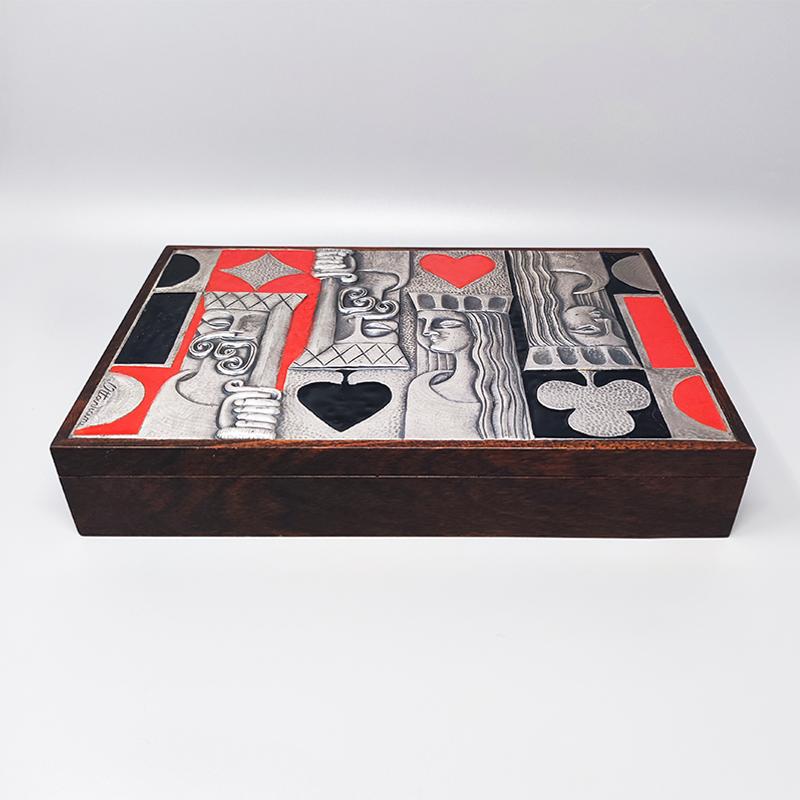 1960s Original gorgeous playing cards box by Ottaviani in sterling silver, enamel and wood The box is signed Ottaviani, 925 mark. Made in Italy. The box is in excellent condition and retains original game pieces.
Dimension:
12,8