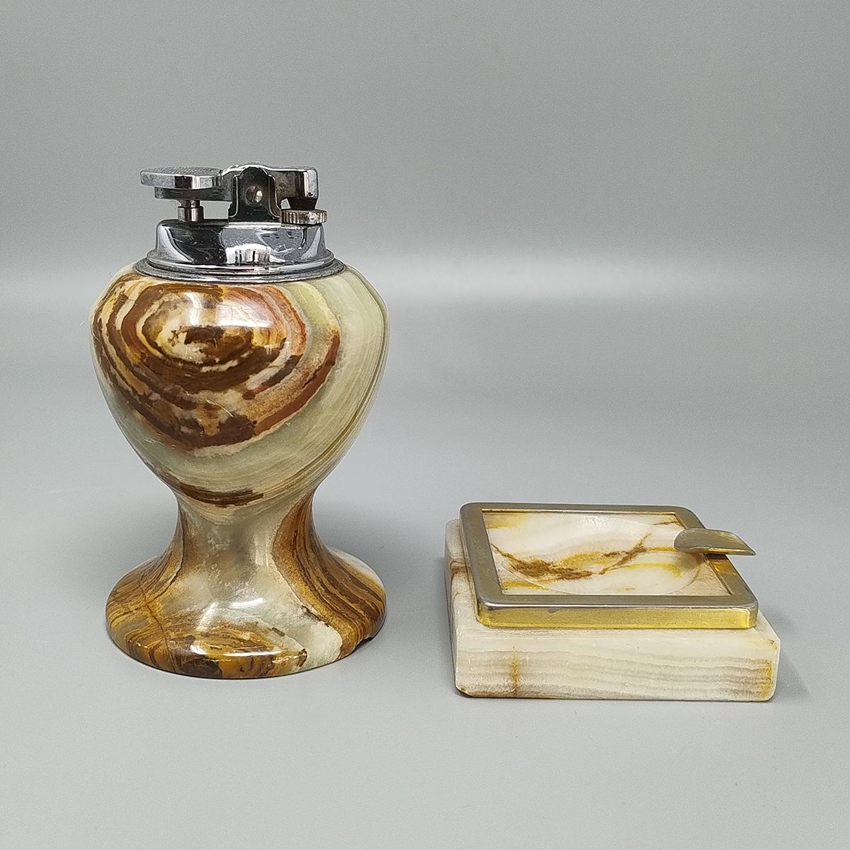 1960s Gorgeous smoking set in onyx. The table lighter works perfectly. Made in Italy. The items are in excellent condition.
Dimension:
Table Lighter
diameter 2,36 x 4,33  H inches
diameter cm 6 x cm 11 H
Ashtray
2,75 x 2,75 x 1,18 H inches
cm 7 x cm