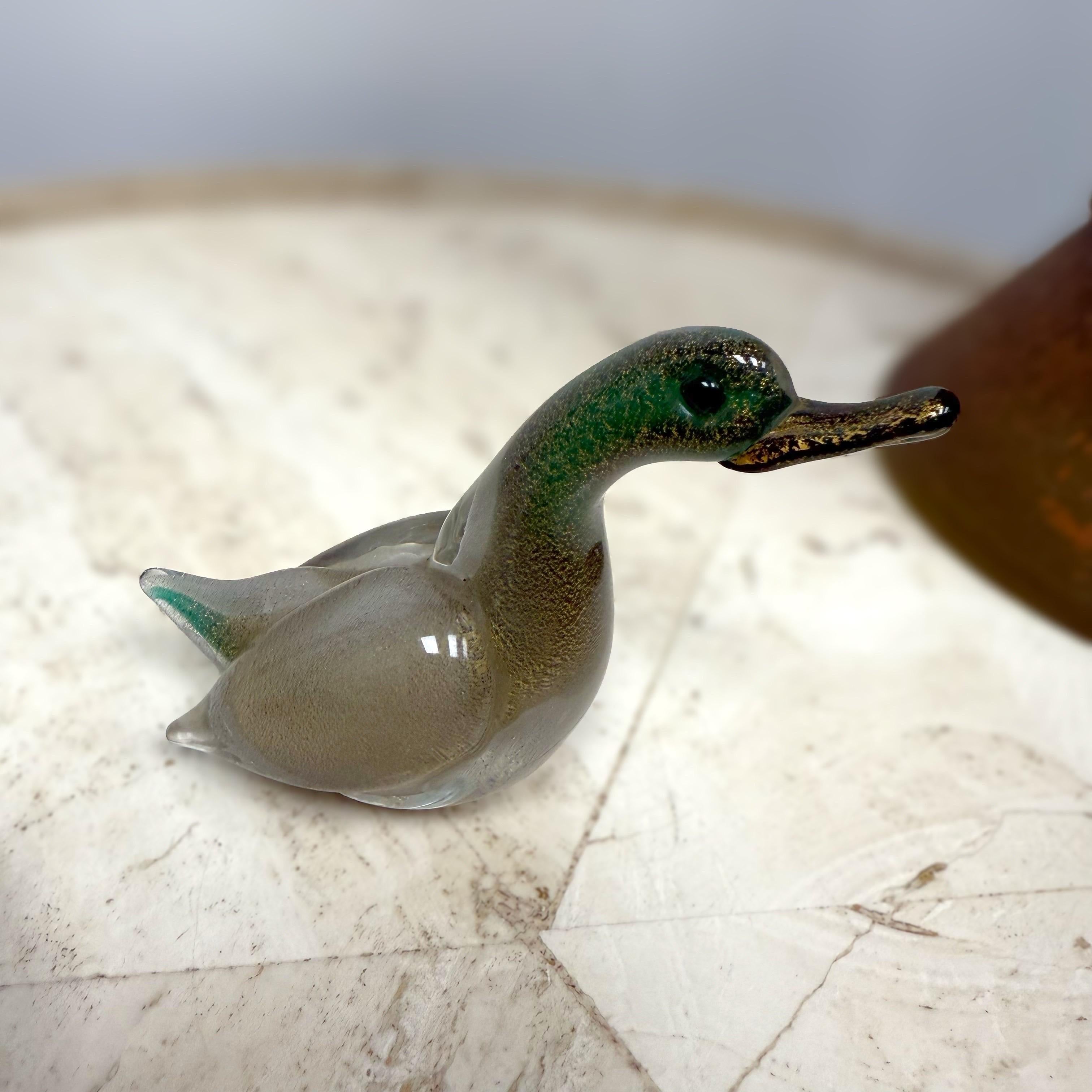 A bilious green, vintage Mid-Century Modern Italian duck made of hand blown colored Murano glass, designed, produced by Paolo Venini and Toni Zuccheri in very good condition. The beak and neck of the bird is made of dark green glass, enhanced by