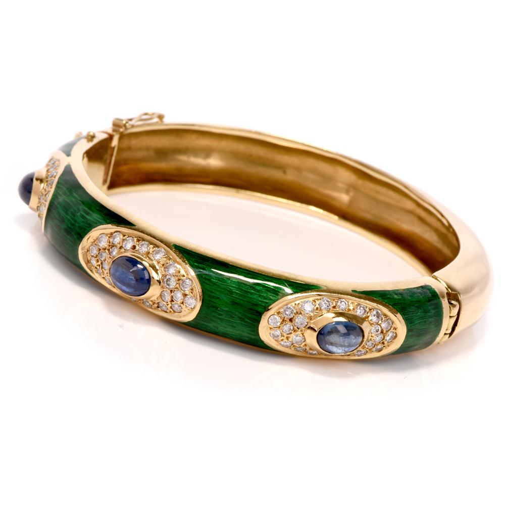 This estate sapphire, diamond, green enamel bangle bracelet is crafted in solid 18k yellow gold. Weighing 54.4 grams and measuring 7”. This bangle bracelet features 3 bezel centered blue sapphires approx.2.00 carats surrounded by approx. 72