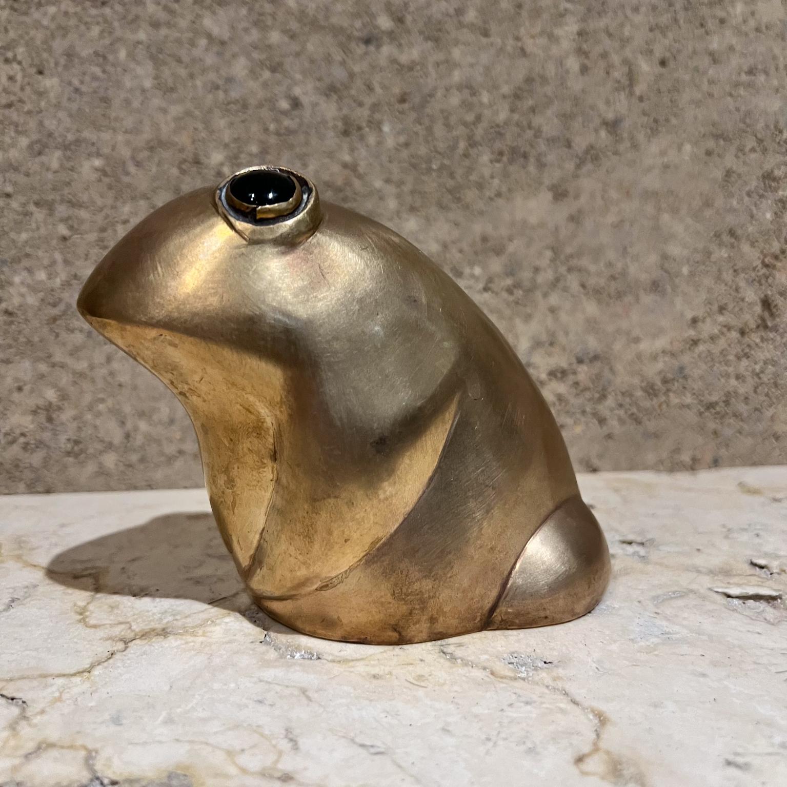 AMBIANIC presents
Fabulous desk or table paperweight- Brass Frog Sculpture 
4 h x 5 d x 3 w
Lovely polished green stones for eyes.
No stamp of signature present.
Preowned vintage condition
Clean finish. Refer to images.