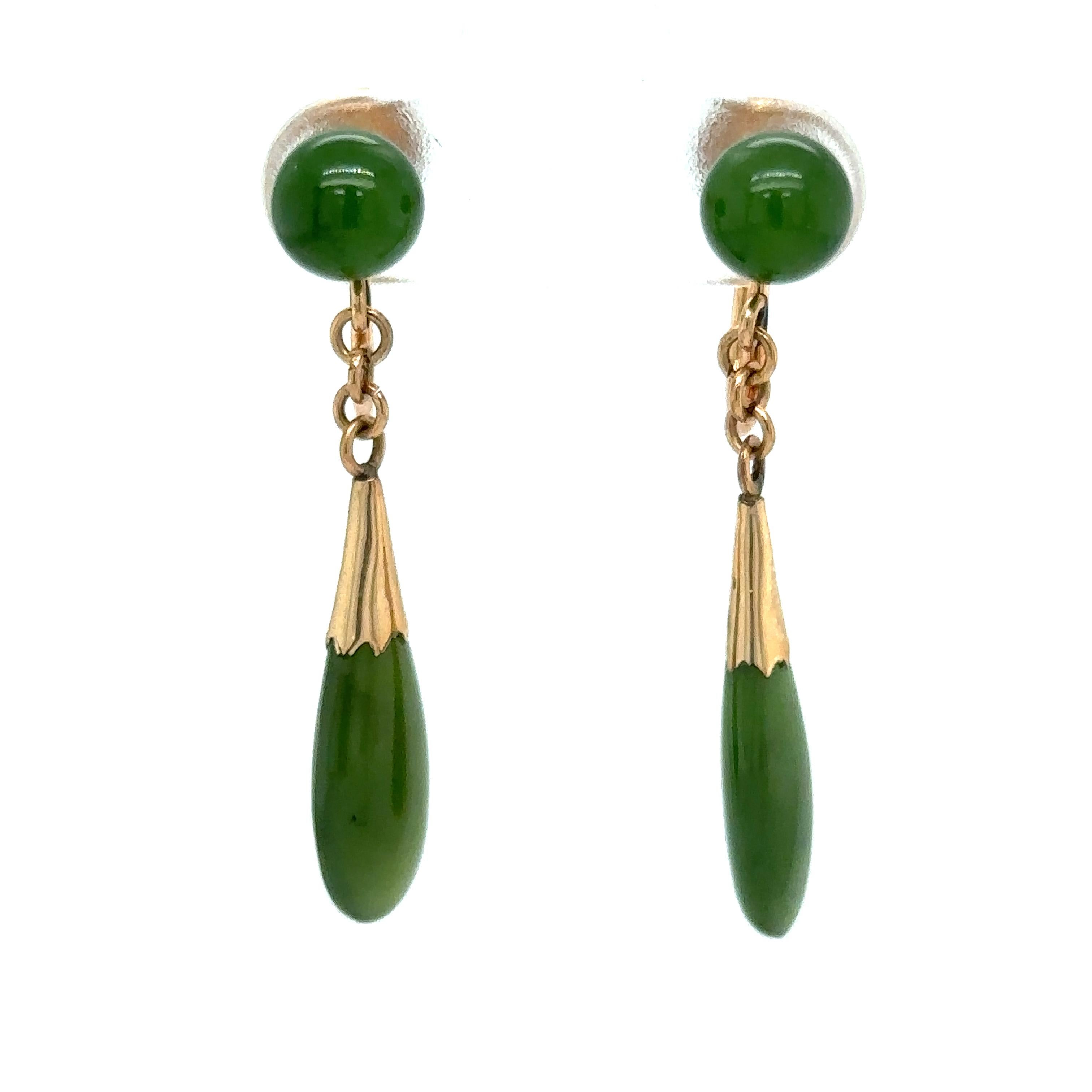 Item Details: These dangle earrings have round jade stones and jade drops with a lush dark green color in a 14k gold setting. These are non-pierced screw back earrings.

Circa: 1960s
Metal Type: 14 Karat Gold
Weight: 3.2 grams
Size: 1 inch Length 