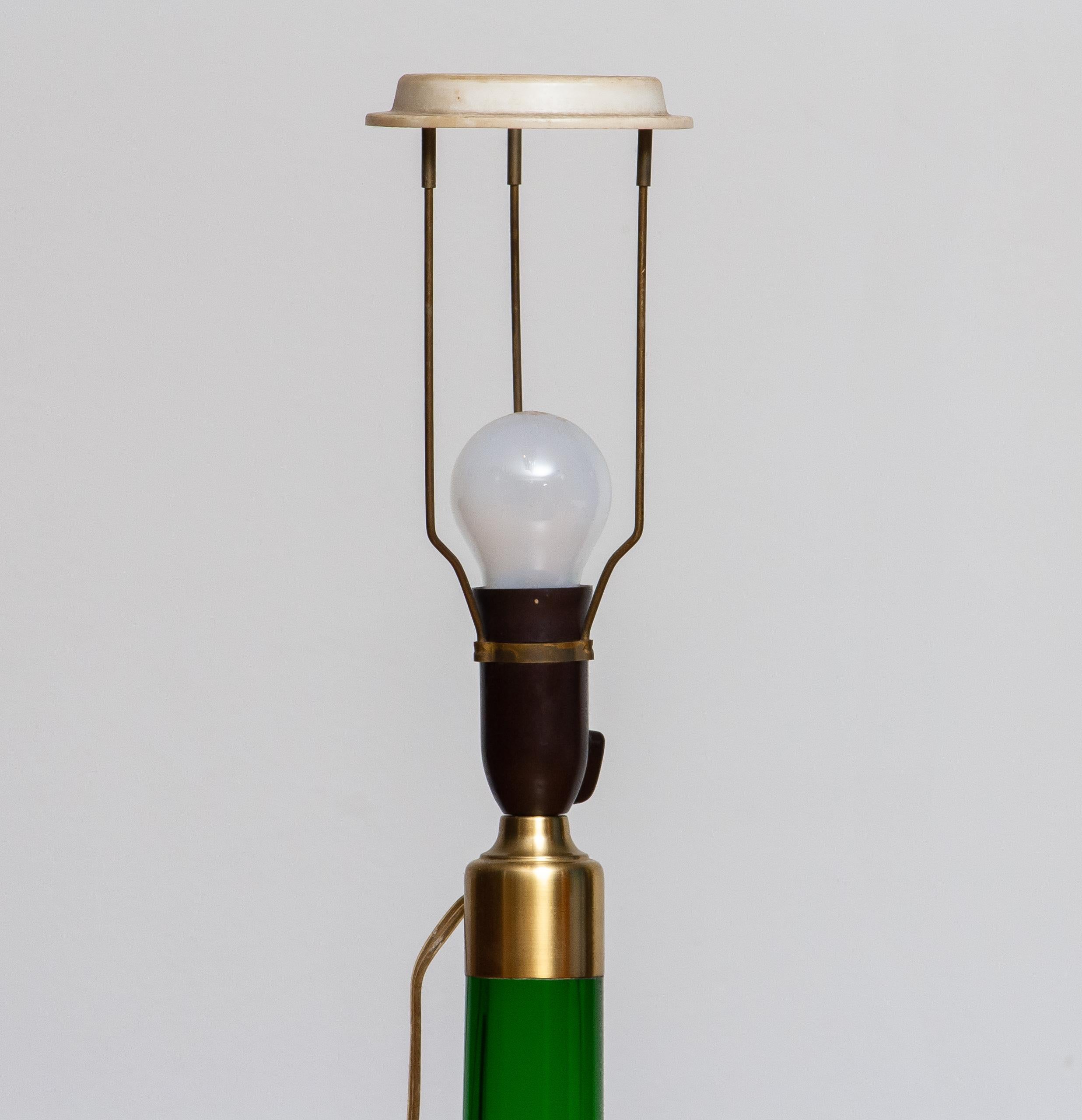 This green, glass, table lamp is manufactured by Holmegaard, Denmark, 1960s.
The elegant design with the slim waist makes the table lamp extremely beautiful.
In perfect condition and technically 100%.
One E28 / E27 bulb. Maximum 75