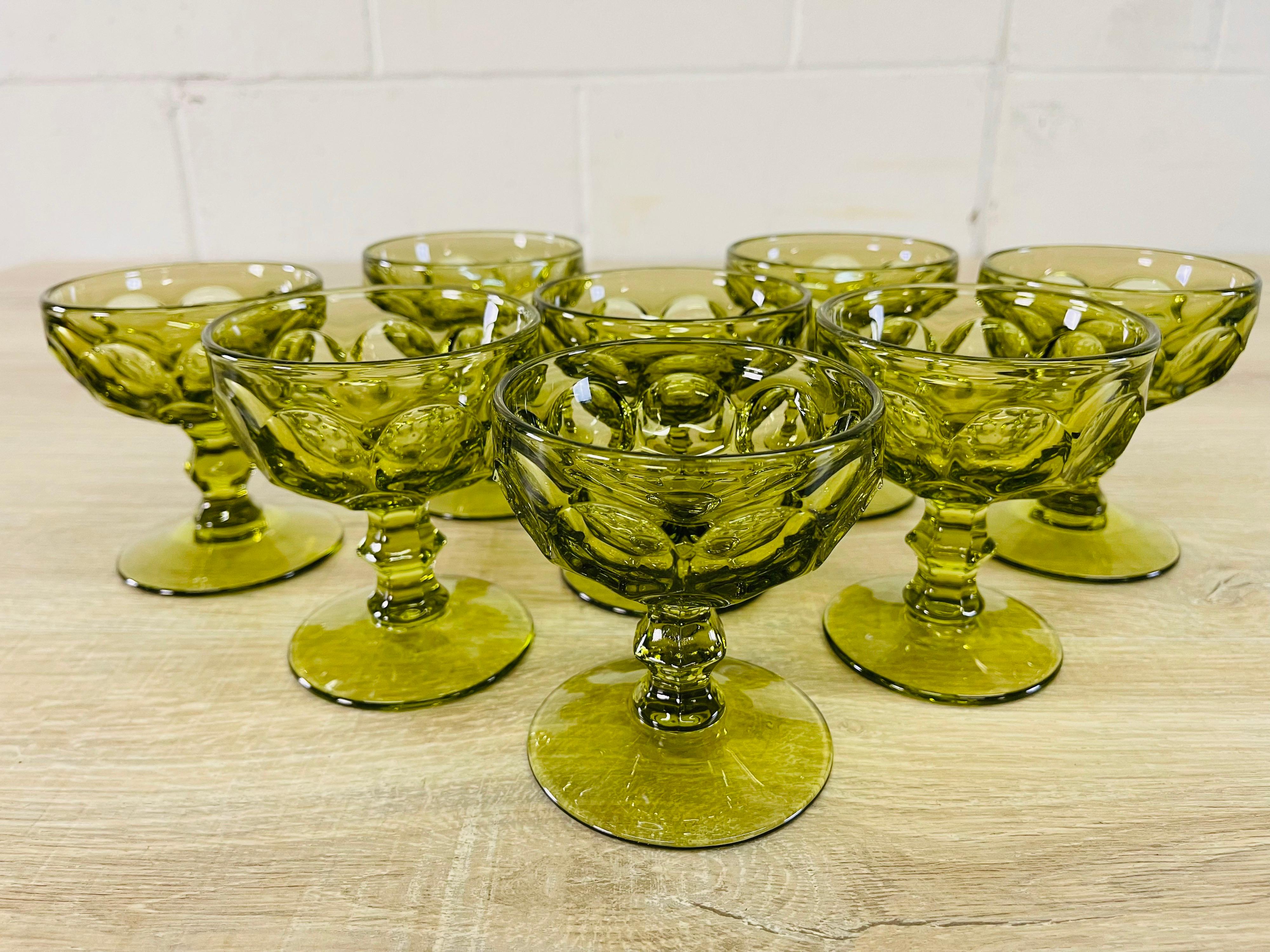 Vintage 1960s set of 8 green thumprint glass coupe stems. No marks.