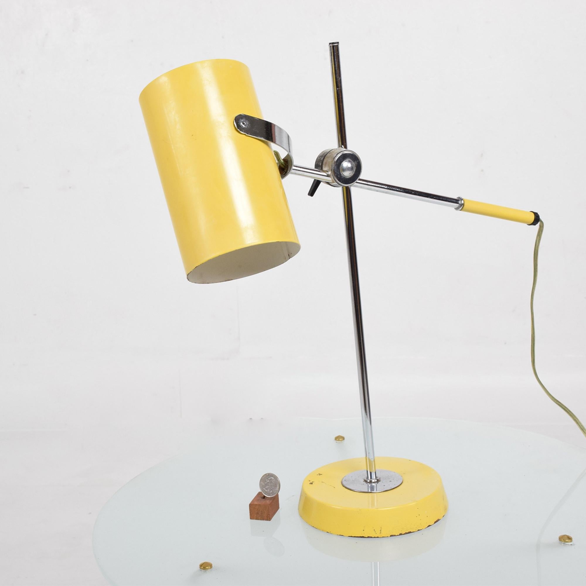 Desk Table Lamp in YELLOW USA circa 1960s.
Style of Greta Grossman, unmarked.
The shade is adjustable. The height is adjustable.
Chrome-plated body with metal or aluminum painted in yellow.
Measures: 20 tall x 17 D x 5.5 W
Shade is 4 in diameter x