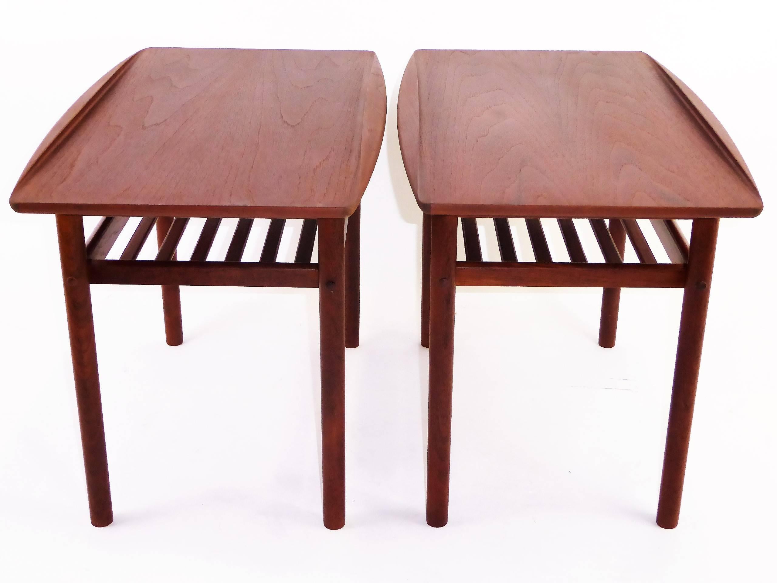 1960s iconic table design by noted Danish designer Grete Jalk and produced by cabinetmaker Poul Jeppesen. Each with a sculpted curled edge and featuring a slatted stretcher shelf. Both have Grete Jalk/Jeppesen labels and Danish Control labels. One