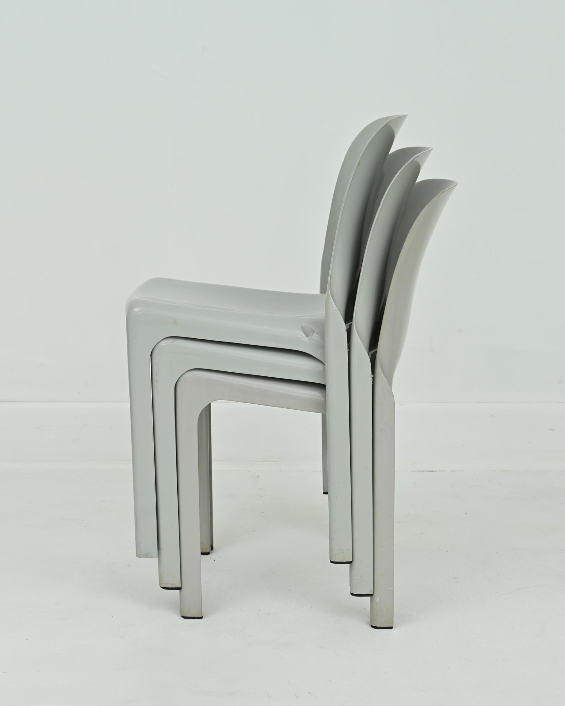1960s grey Selene chair by Vico Magistretti for Artemide. These chairs were molded out of grey fiberglass-reinforced plastic as single pieces. Stackable and suitable for both indoor and outdoor use. Very good condition with some wear from age. Part