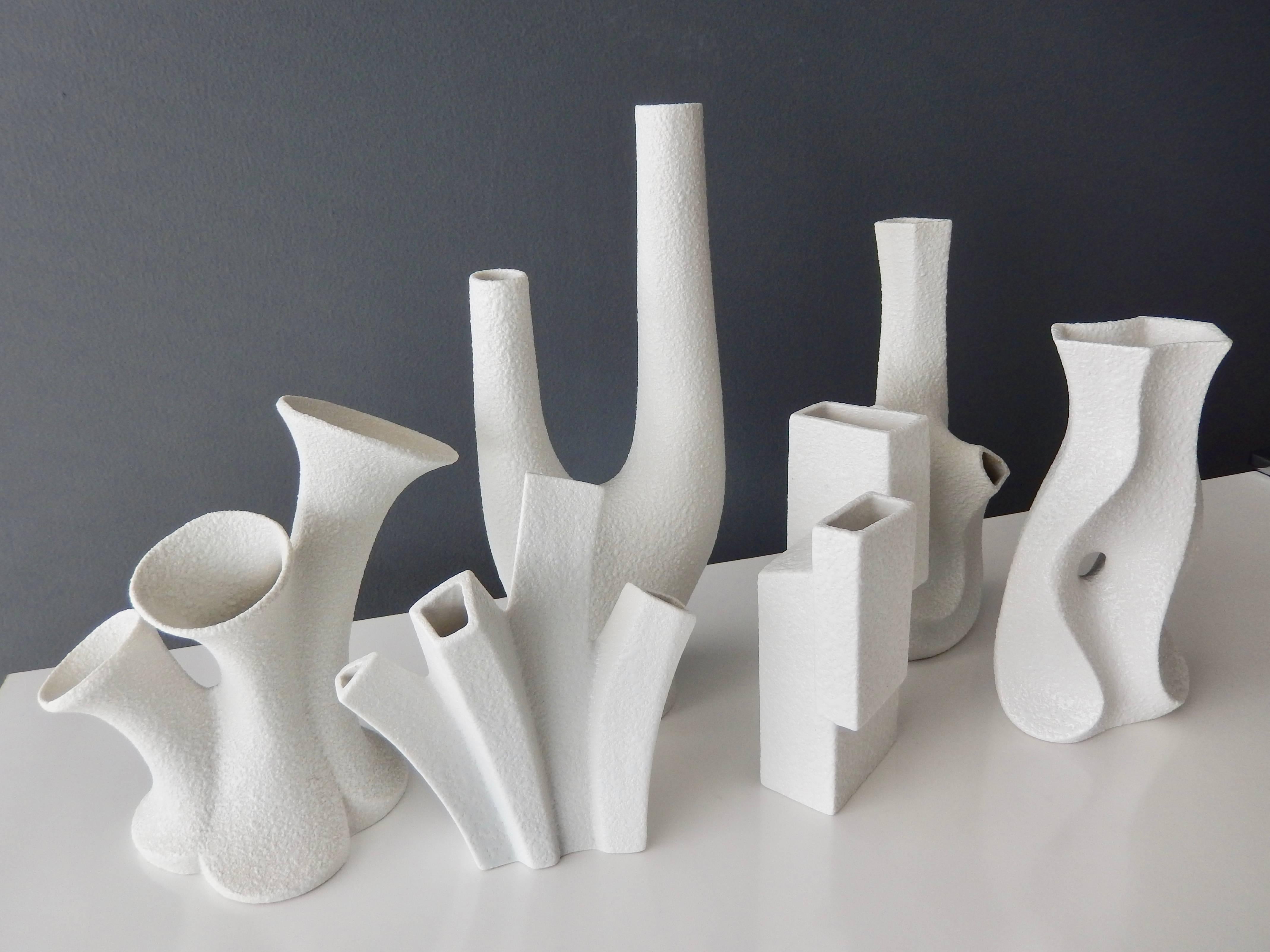 A group of six white porcelain vases by the innovative designer Peter Muller for Sgrafo Modern of West Germany.

In 1955 two brothers, Peter and Klaus Muller opened a small porcelain factory in Germany and created some of the most modern,