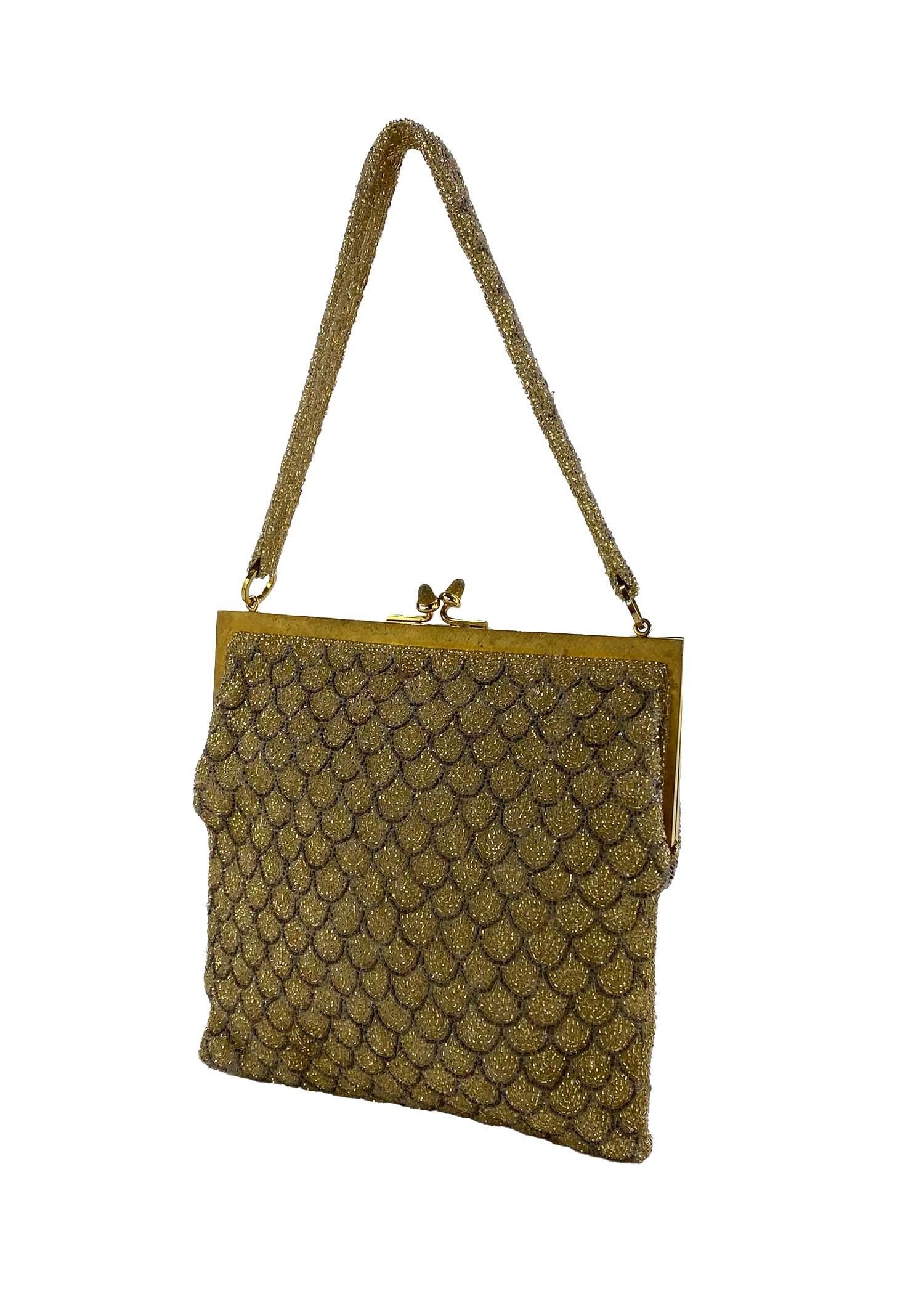TheRealList presents: a very vintage beaded Gucci evening bag. This stunning bag is likely from the 1960s and is completely made of caviar beads fashioned in a scallop pattern around a gold colored metal frame with a kiss lock. From the early days
