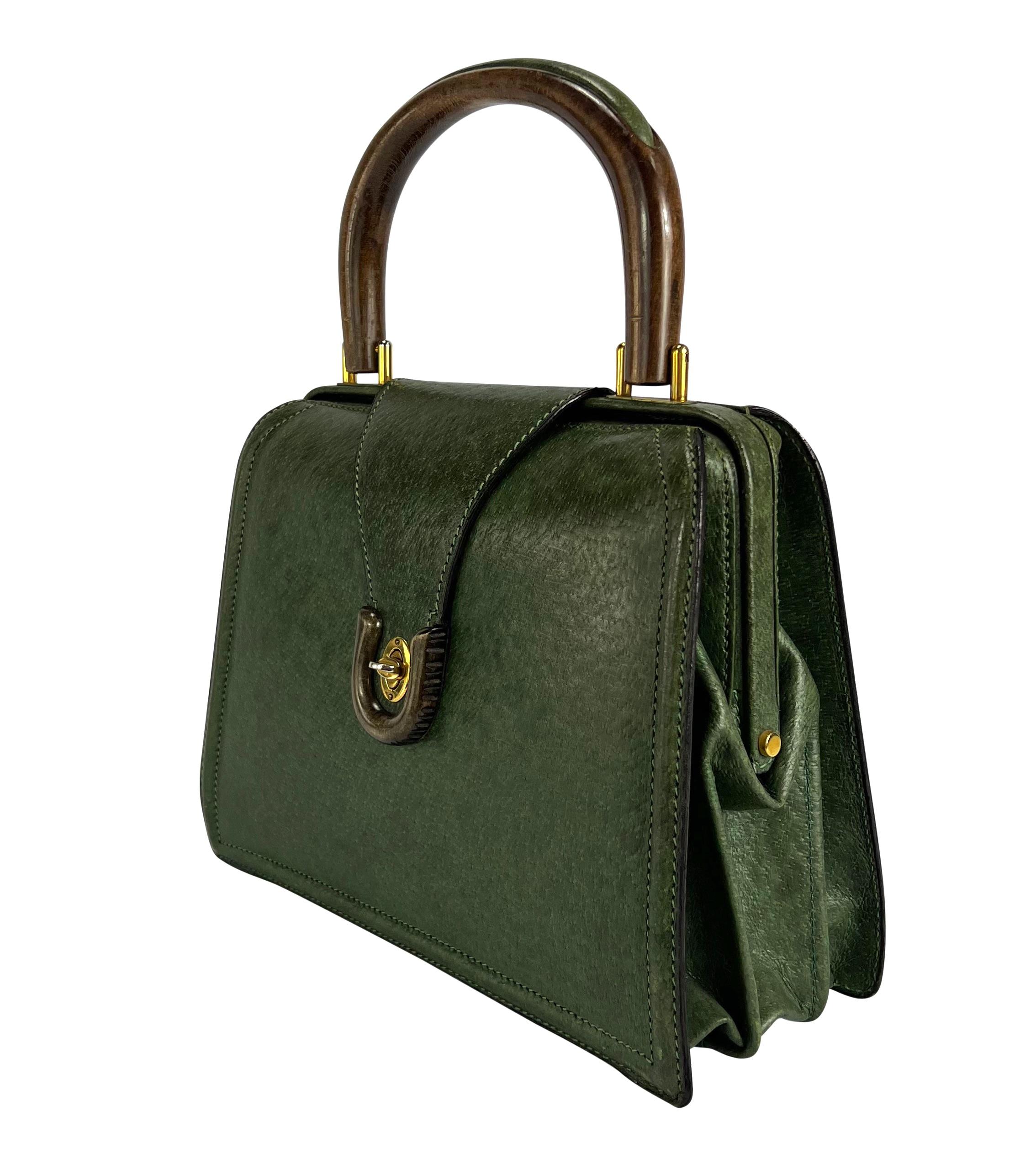 TheRealList presents: a fabulous hunter green boar leather top handle Gucci bag. From the 1960s, this fabulous accordion-style bag features gold-tone hardware, a wooden handle, and a flap closure secured with a turn lock. Add this unique and