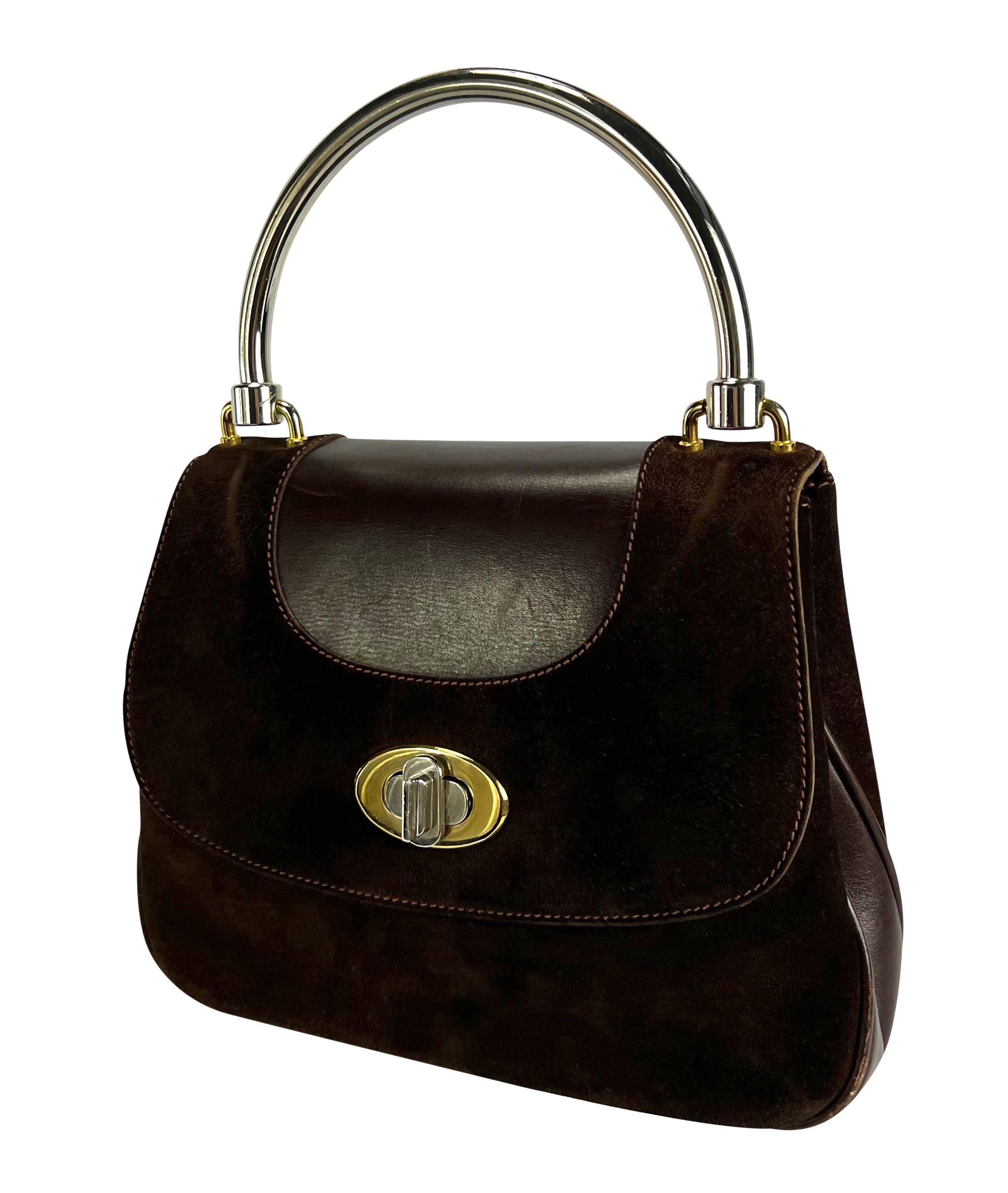 Presenting a vintage 1960s Gucci structured leather top handle bag. This classicly designed bag features a dual-tone metal handle and closure. The brown suede perfectly contrasts the shine of the two-tone hardware. Grab this classic piece of Gucci