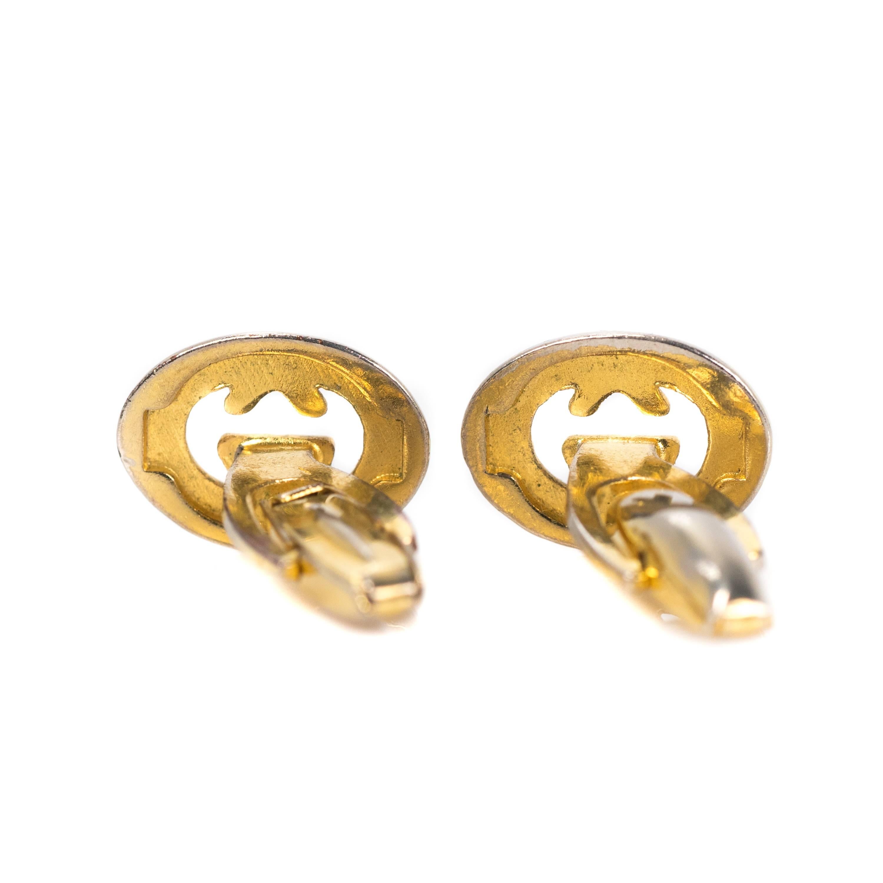 1960s Gucci Two Tone, Bullet Back Cufflinks 

Features the iconic Gucci logo in two tone metal.
Interlocking silver letters G are framed by an oval of gold within a silver border. The inner edges of the letters G and the backs of the cufflinks are