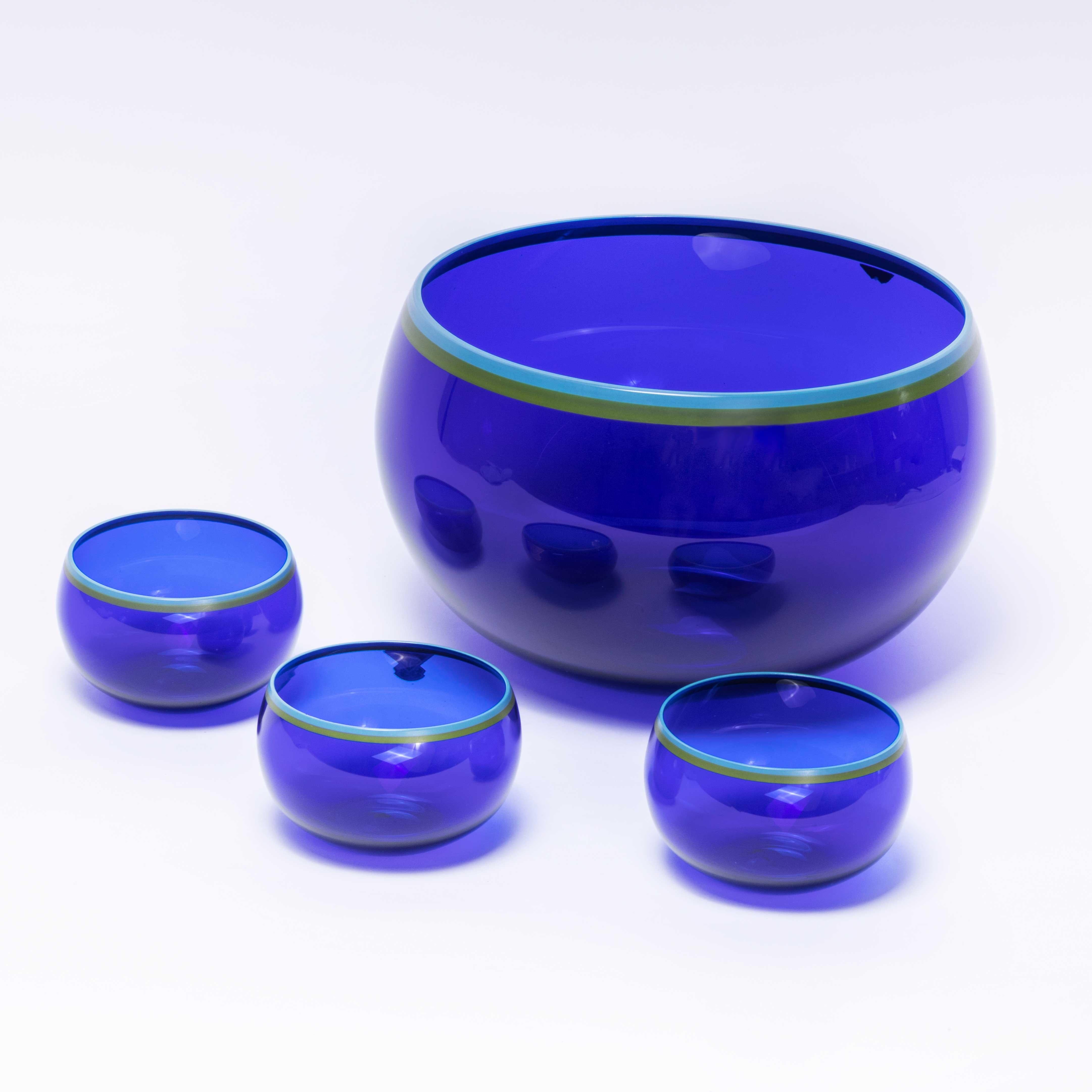 1960’s Gullaskruf Blue glass bowl set – Four pieces
1960’s Gullaskruf Blue glass bowl set – Four pieces. Designed by Catti Aselius Lidback and made by Gullaskruf of Sweden in the 1960’s. The set features a large single bowl and three smaller bowls.