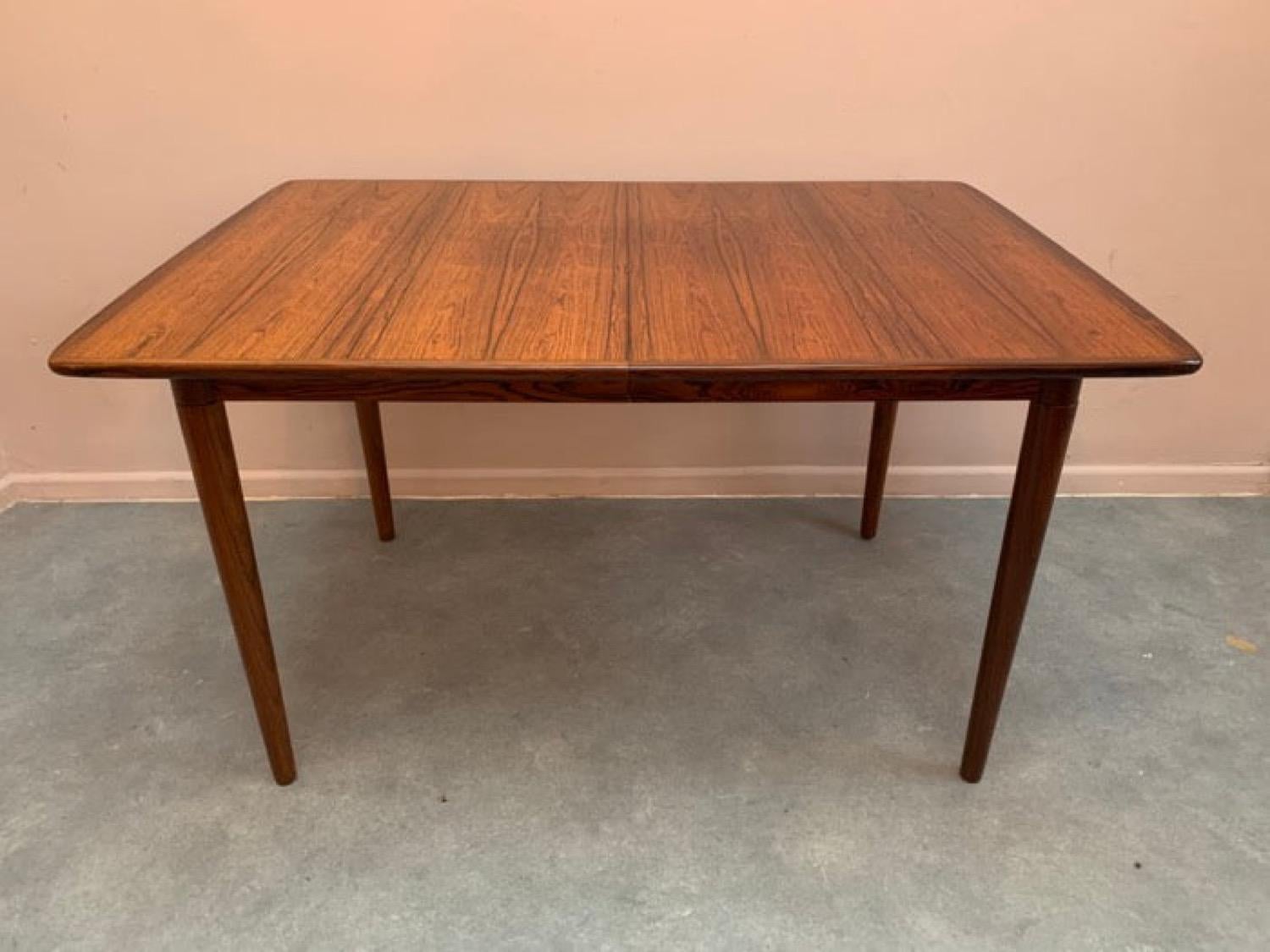 A stunning 1960s Norwegian rosewood dining table designed by Rolf Rastad & Adolf Relling and manufactured by Gustav Bahus. Model no 14. In very good condition with a beautiful deep patina and grain with some minor sun fading. The table is a compact