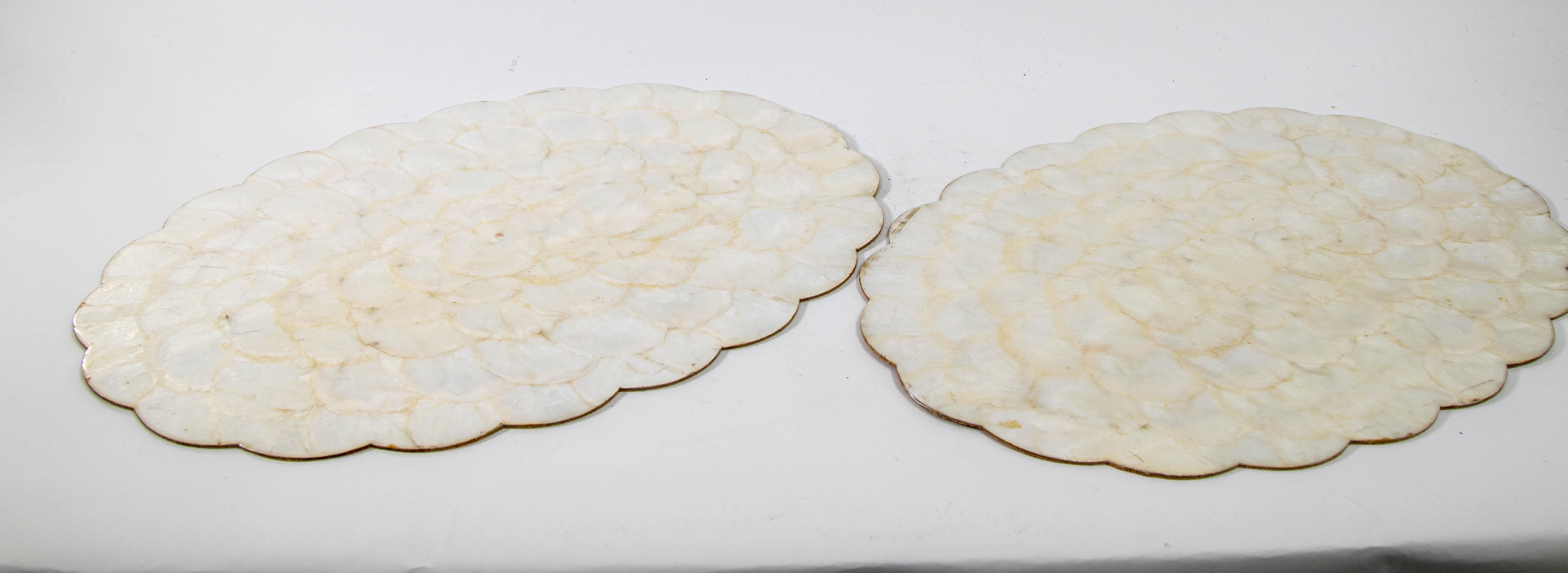 Vintage Hallie St Mary placemats, set of two capiz, abalone, pearl shell design scalloped edge oval placemats.
Luminous, beautiful mother of pearl shell color.
The reverse of these placemats is cork.
These would make a beautiful, tropical and