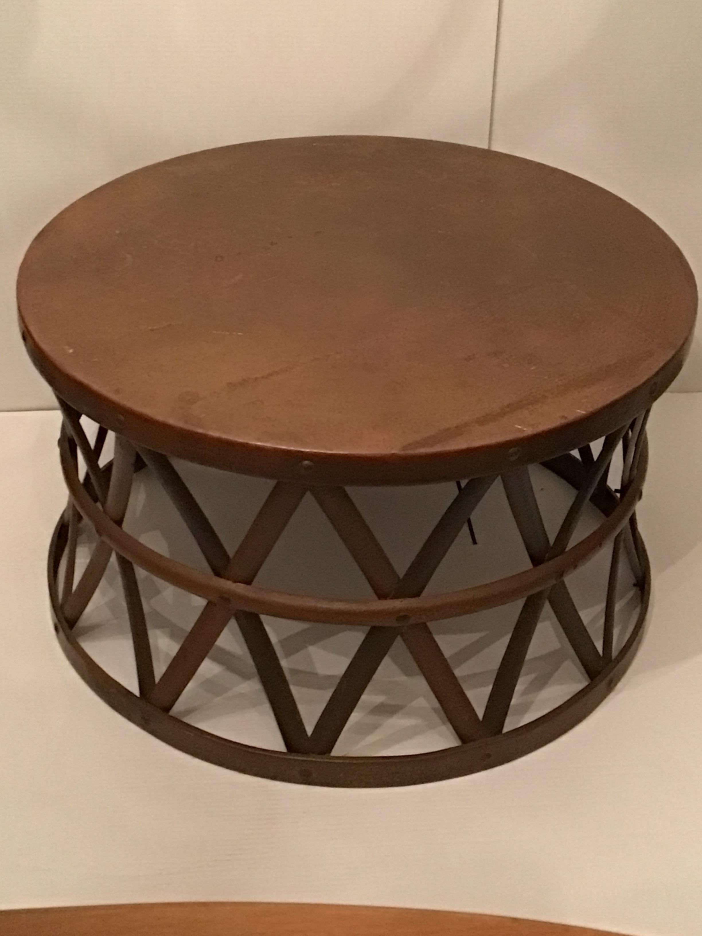 This 1960s Hammered Copper and Brass Drum Table features a Hammered Copper tabletop which has developed a patina
There are spots on the tabletop (as shown in pictures) which only add to richness of the piece
Hammered metal strap base 