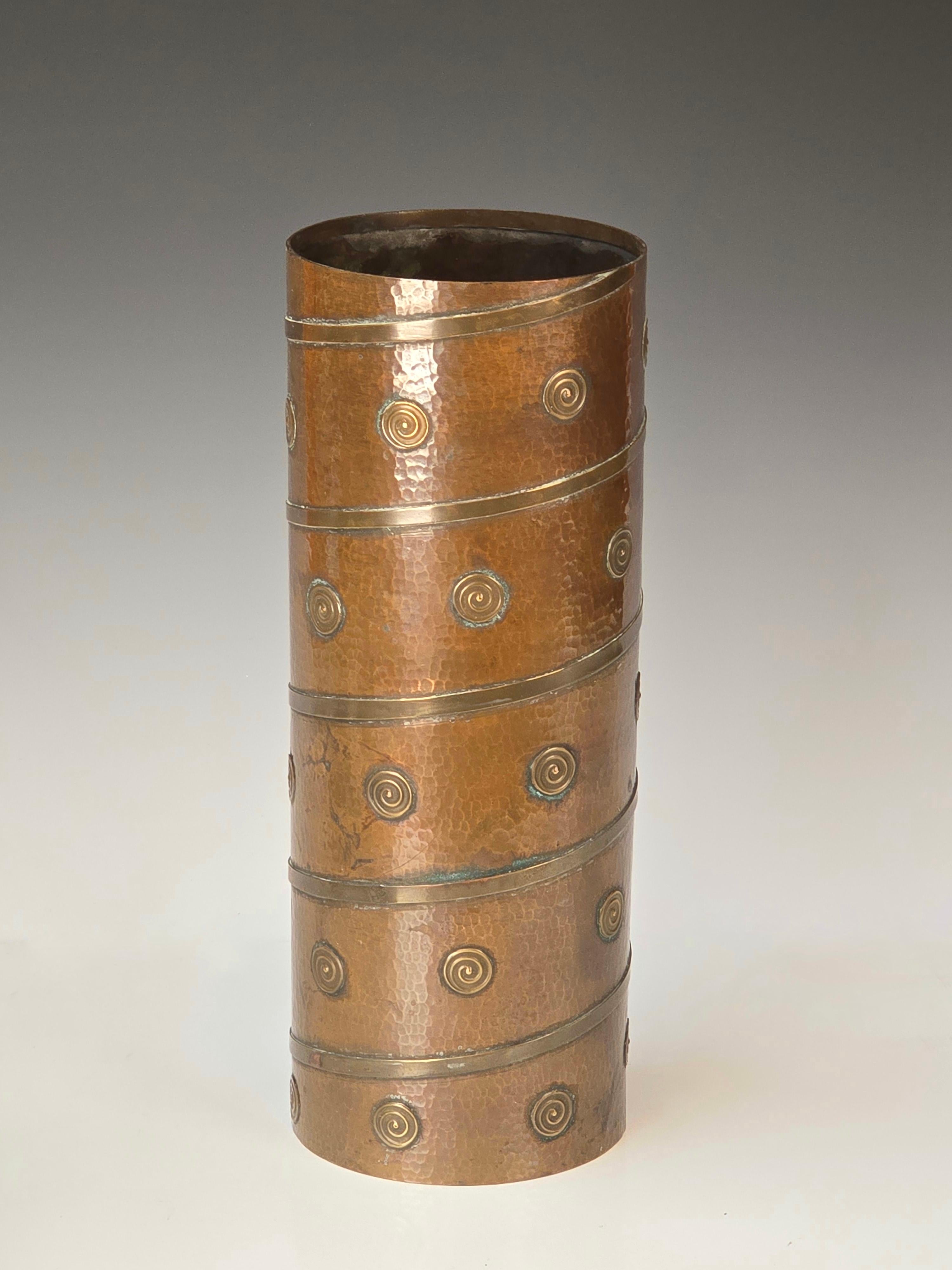 Stylish hammered copper and brass vase made in Pakistan in the 1950-1960s.   Beautiful rich age acquired patina.   Even though this is an older piece it definitely fits with today's interiors. 