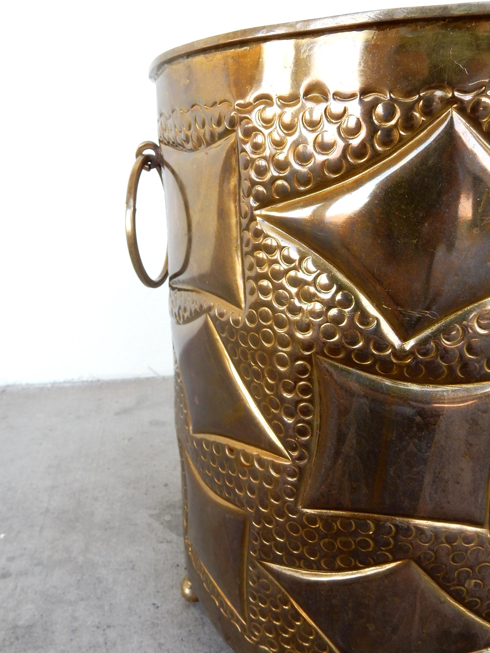 Very unique brass cachepot with random hand-hammered cubist shapes and dots.
Large brass ring handles and 3 ornate feet.
Stands 16