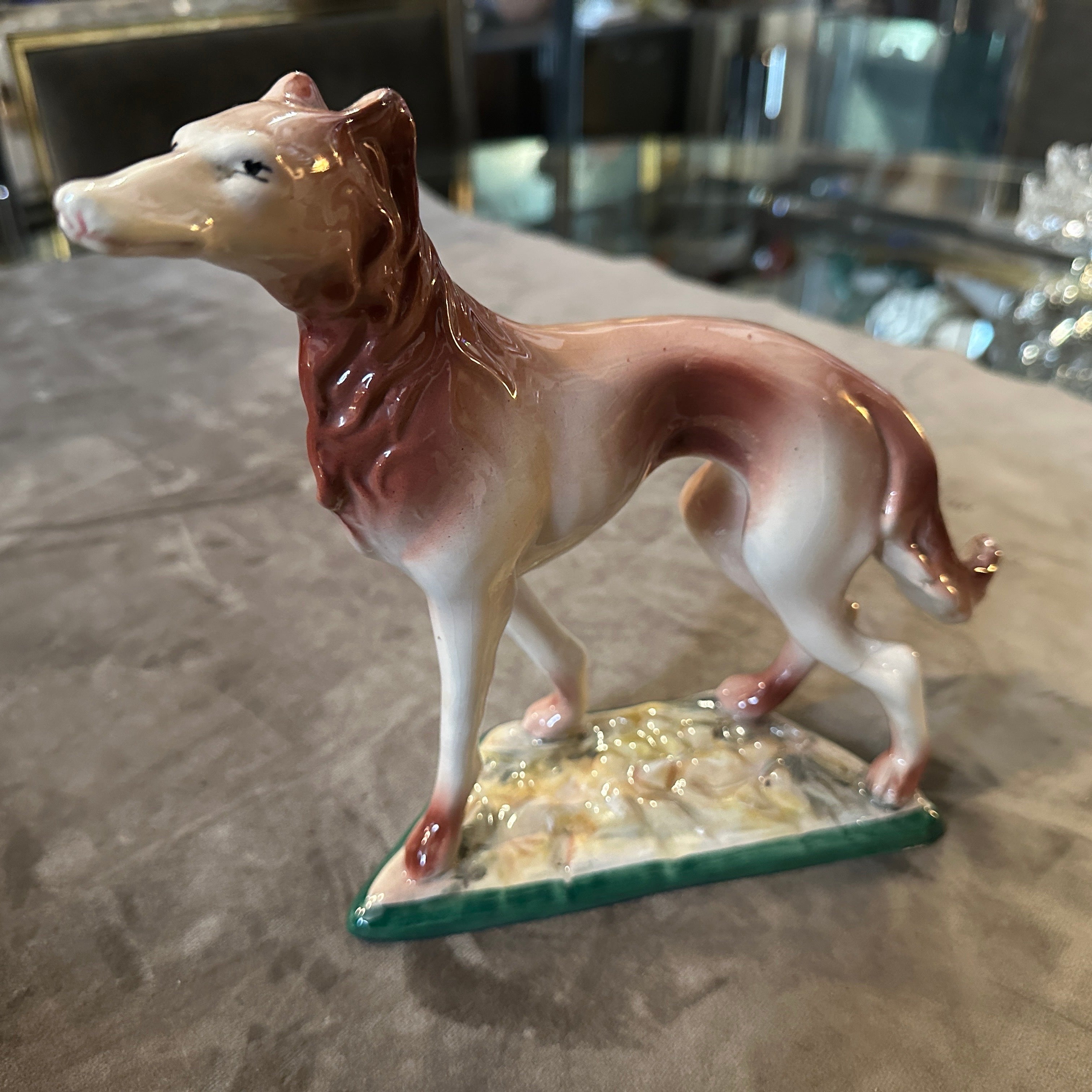 This 1960s hand-crafted and painted porcelain figure of a greyhound by Elsa Lagorio is a charming example of mid-century modern design and ceramic artistry. It beautifully captures the elegance and spirit of the breed while showcasing the artist's