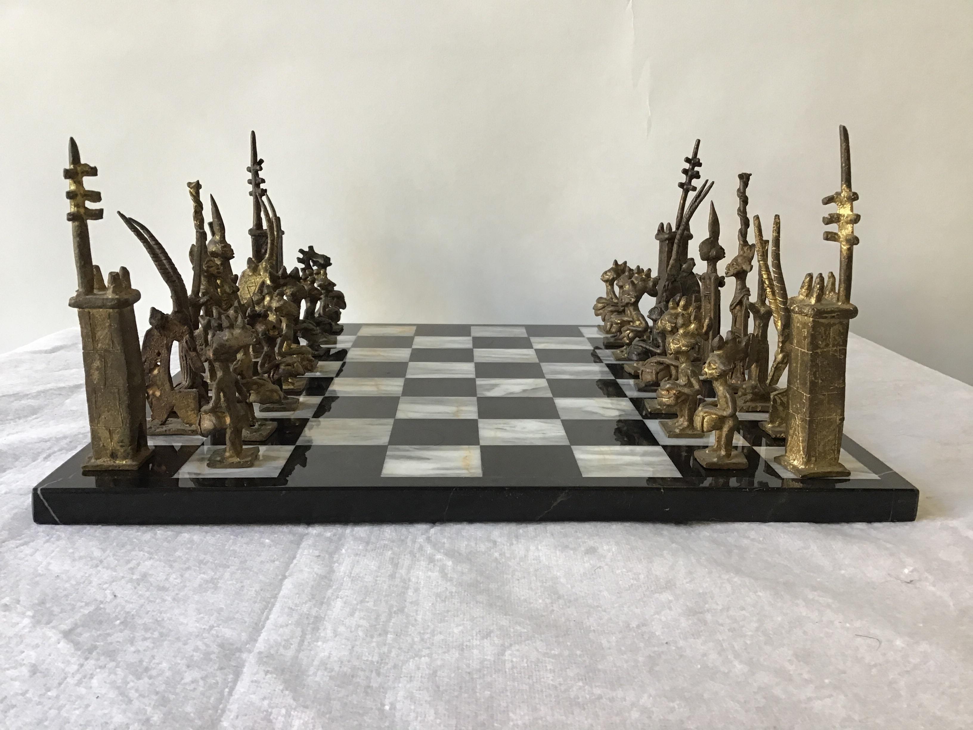 1960s African handmade brass chess set on marble board.