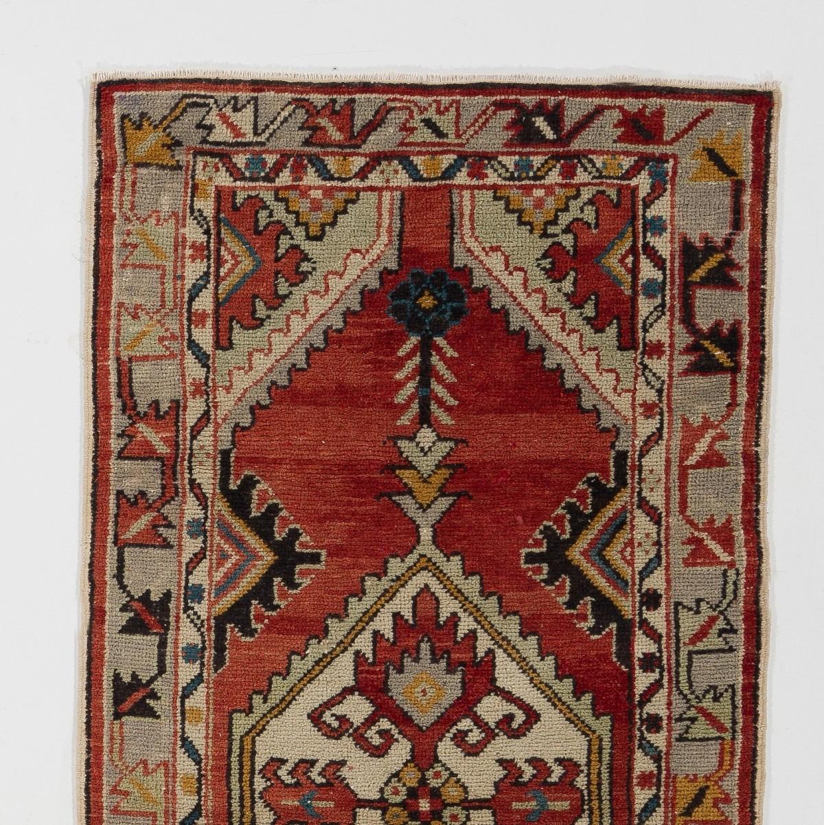 A finely hand-knotted vintage Turkish carpet from 1960s and features a geometric design.
The rug is made of medium wool pile on wool foundation. It is heavy and lays flat on the floor, in very good condition with no issues. It has been washed