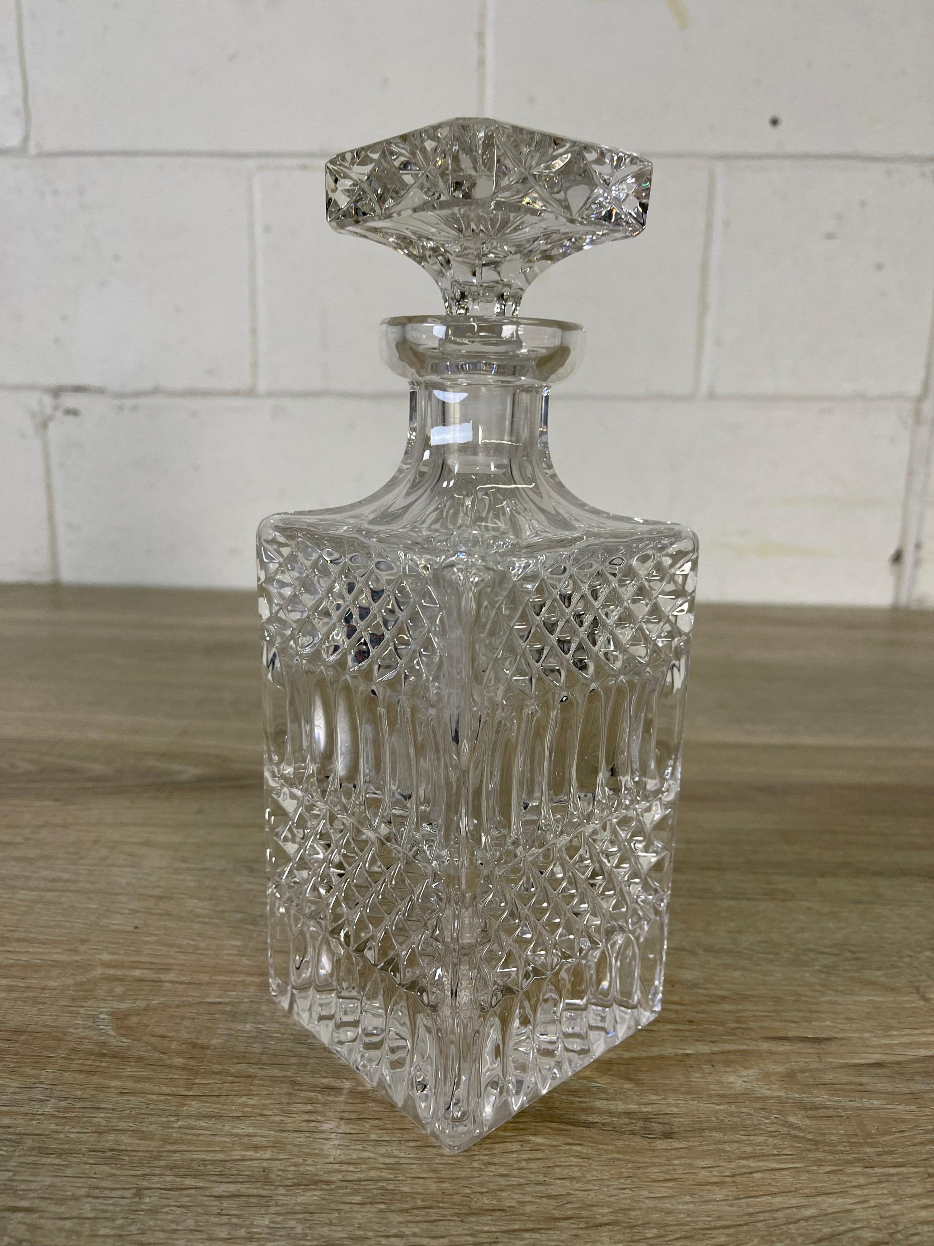 Vintage 1960s handblown square crystal decanter with stopper. The decanter is a heavy glass with no interior stains. No marks.