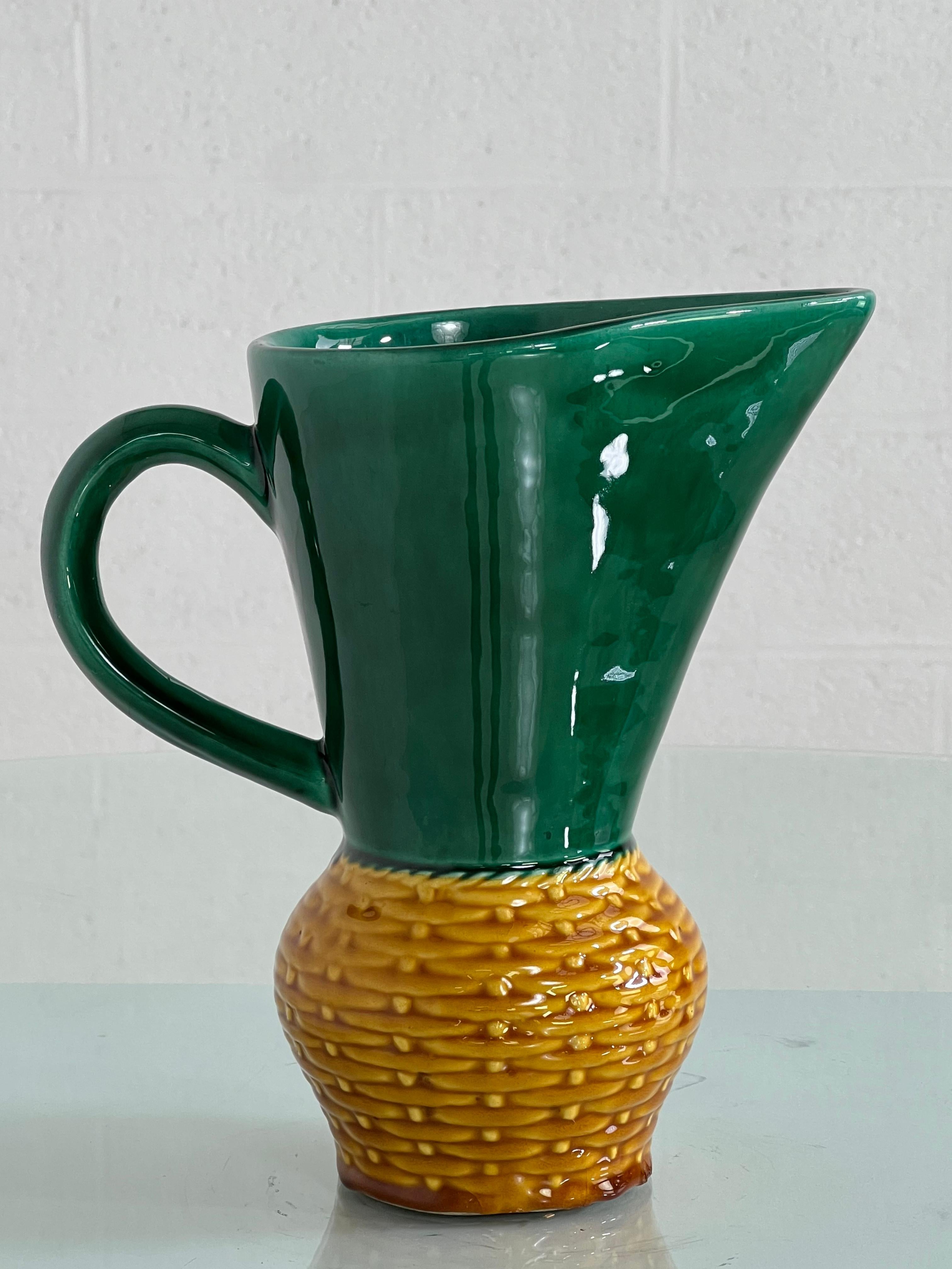 1960s Handmade Ceramic Pitcher Vase with a beautiful emerald color and yellow base in a braided wicker cane effect.