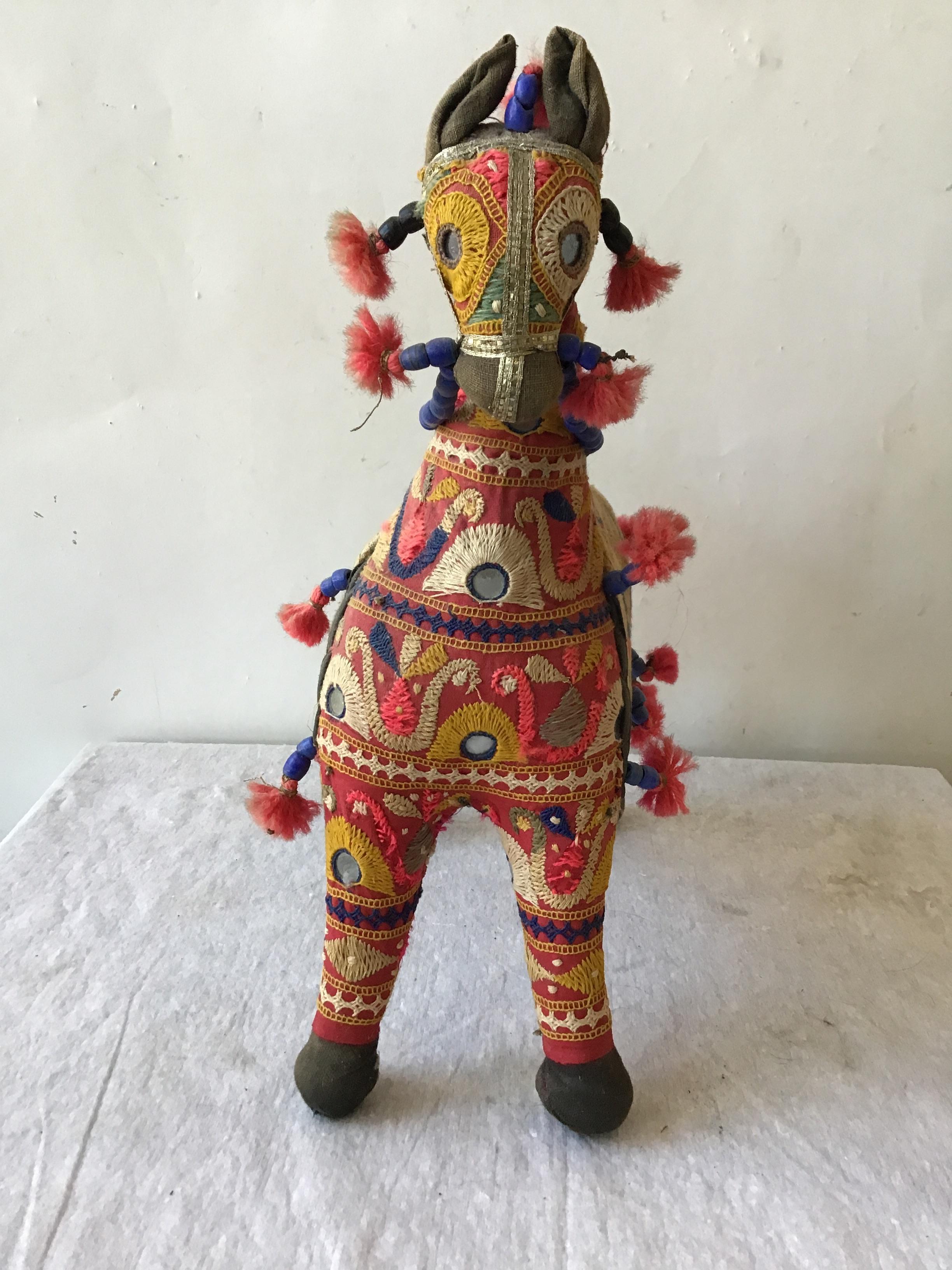 1960s handmade stuffed horse toy from India. Embroidered fabric decorated with mirrors and beads.