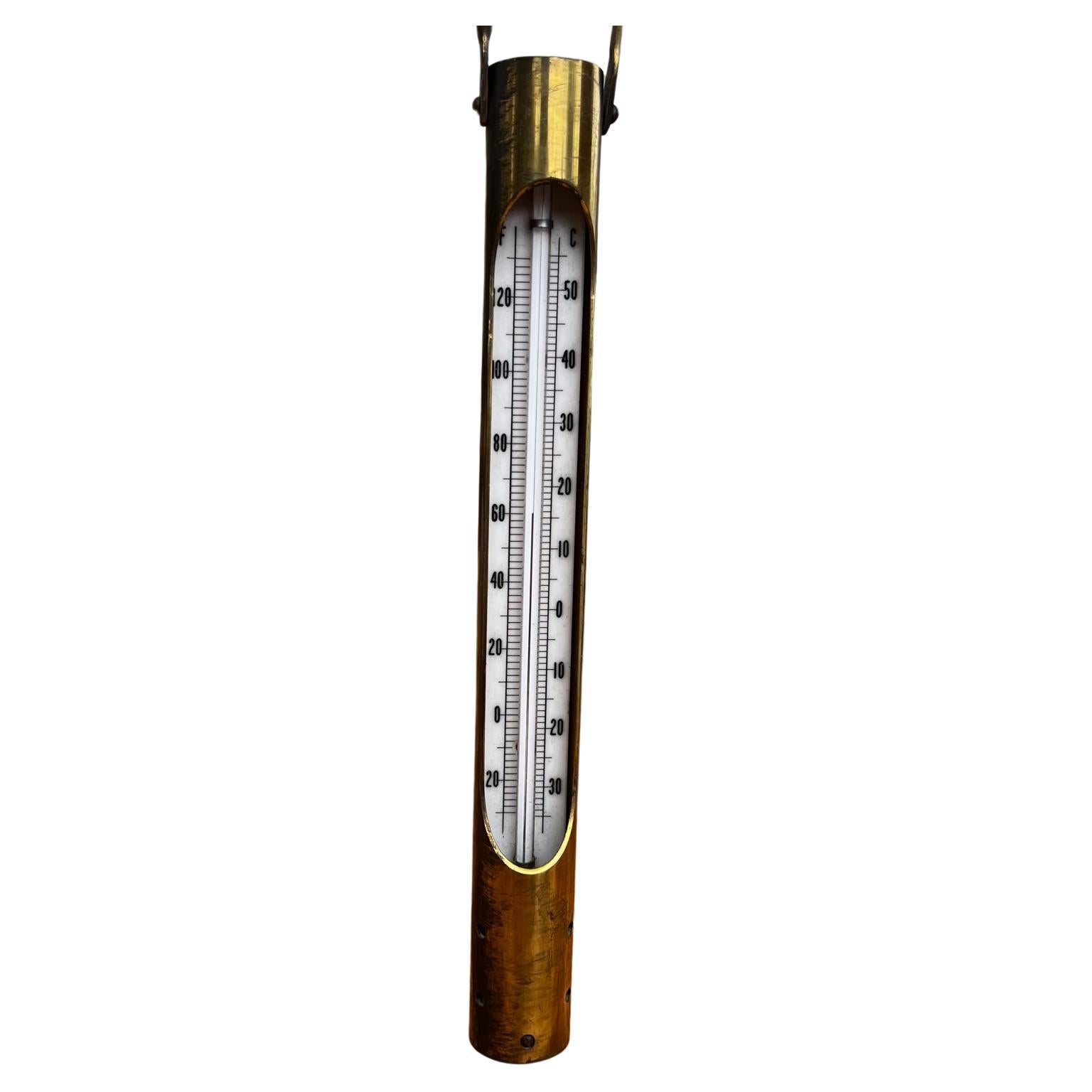 Brass Temperature Gauge
1960s Modern Decorative Brass Hanging Temperature Thermometer Gauge
Solid Brass and Cork
10 tall 3.5 tall with handle x 1.13 in diameter
Preowned original vintage patinated condition unrestored.
Review images provided.