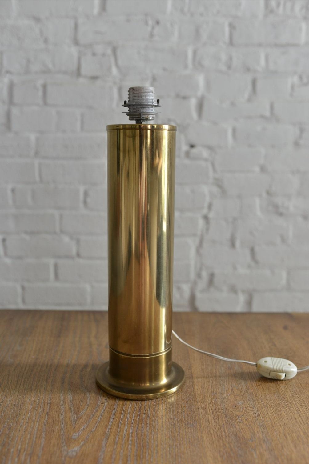 Original all brass Hans Agne Jakobsson for AB Markaryd table lamp made in Sweden. Features a tall brass column form, ceramic standard socket and original cord. The fixture works and is in fantastic vintage condition. Original red shade included but