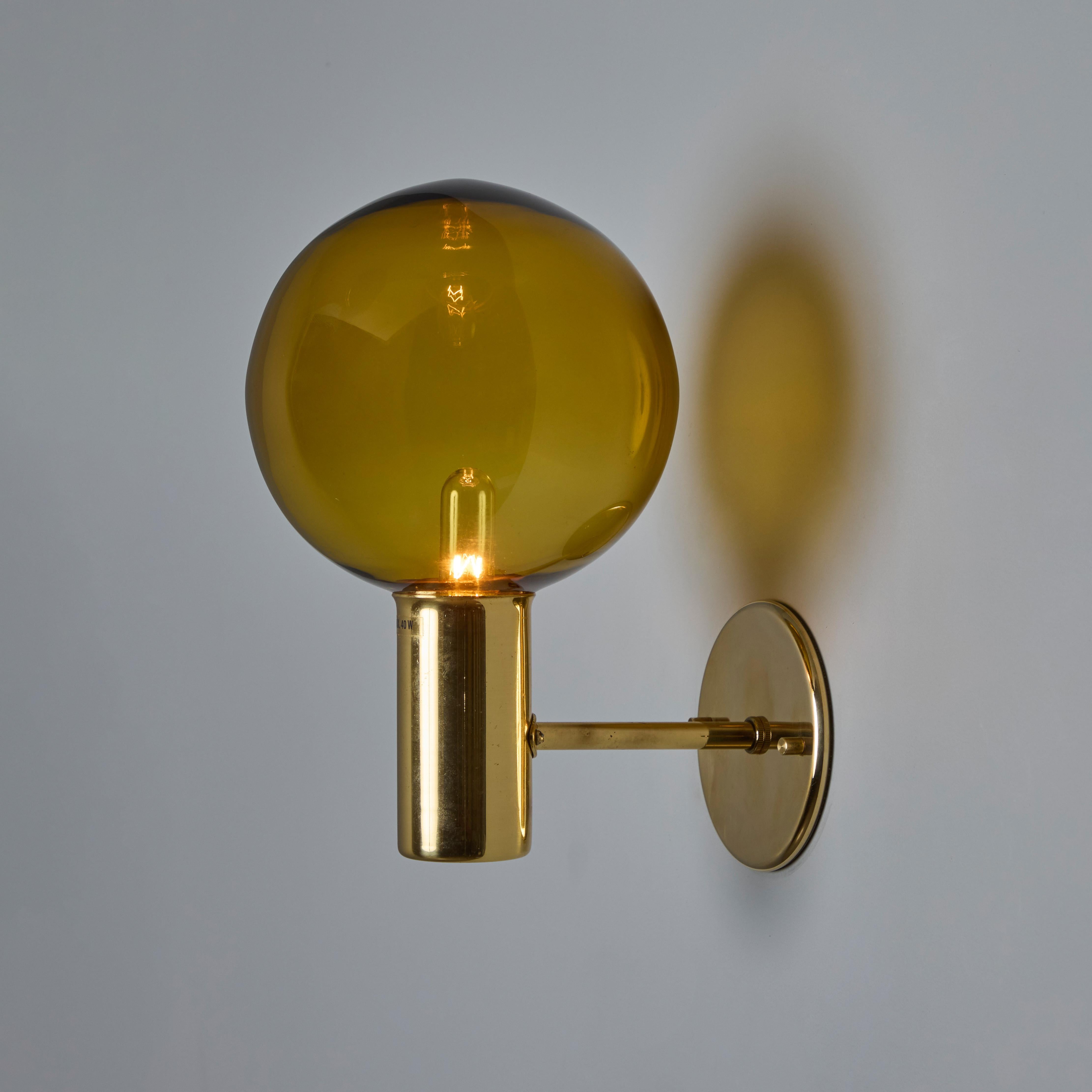 1960s Hans Agne Jakobsson Model V149 Glass and Brass Wall Lamp for Markaryd

An incredibly refined vintage design that is quintessentially Swedish. Executed in sculpturally bent brass and blown round orange glass shades. Original labels on glass and
