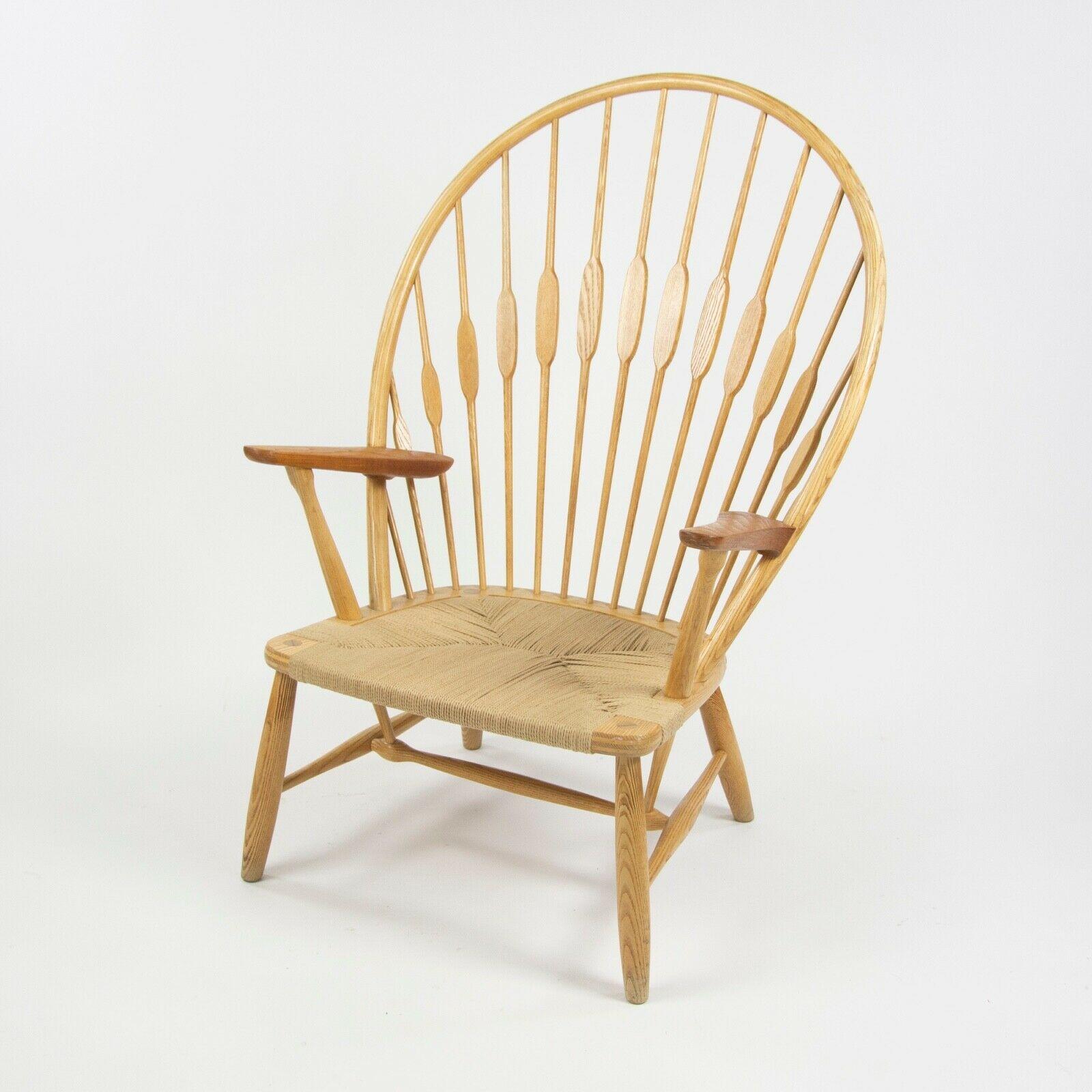 Listed for sale is an original Peacock Chair, designed by Hans Wegner and produced by Johannes Hansen in Copenhagen, Denmark. This example is in very good vintage condition with some light wear and signs of use. It has a lovely patina to the legs