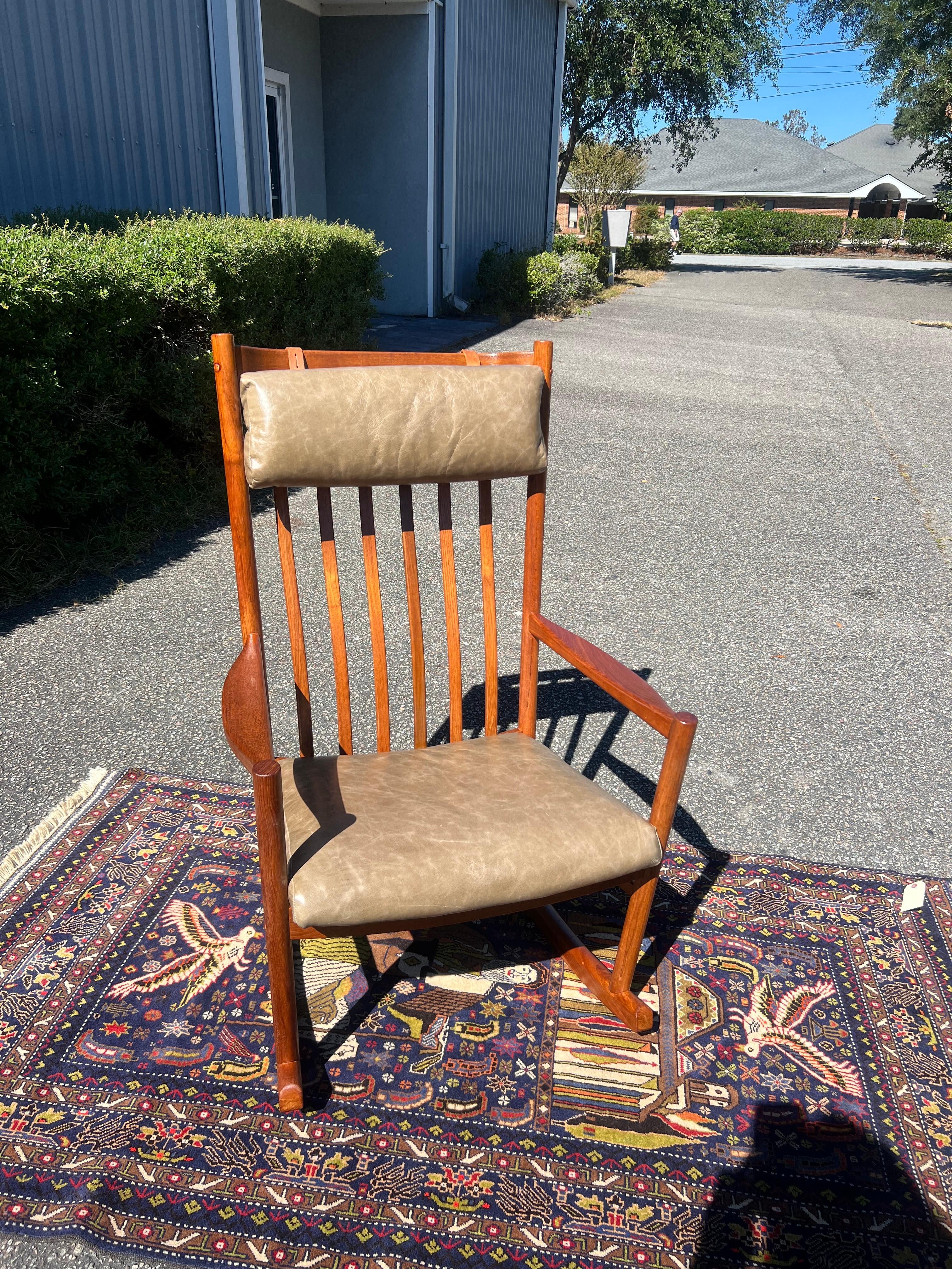1960s Hans Wegner for Tarm Stole teak rocking chair in green leather, newly upholstered in a buttery soft Italian olive green leather and a full refinish. 

This is a beautiful Hans J. Wegner rocking chair in teak. Stunning example of Danish design