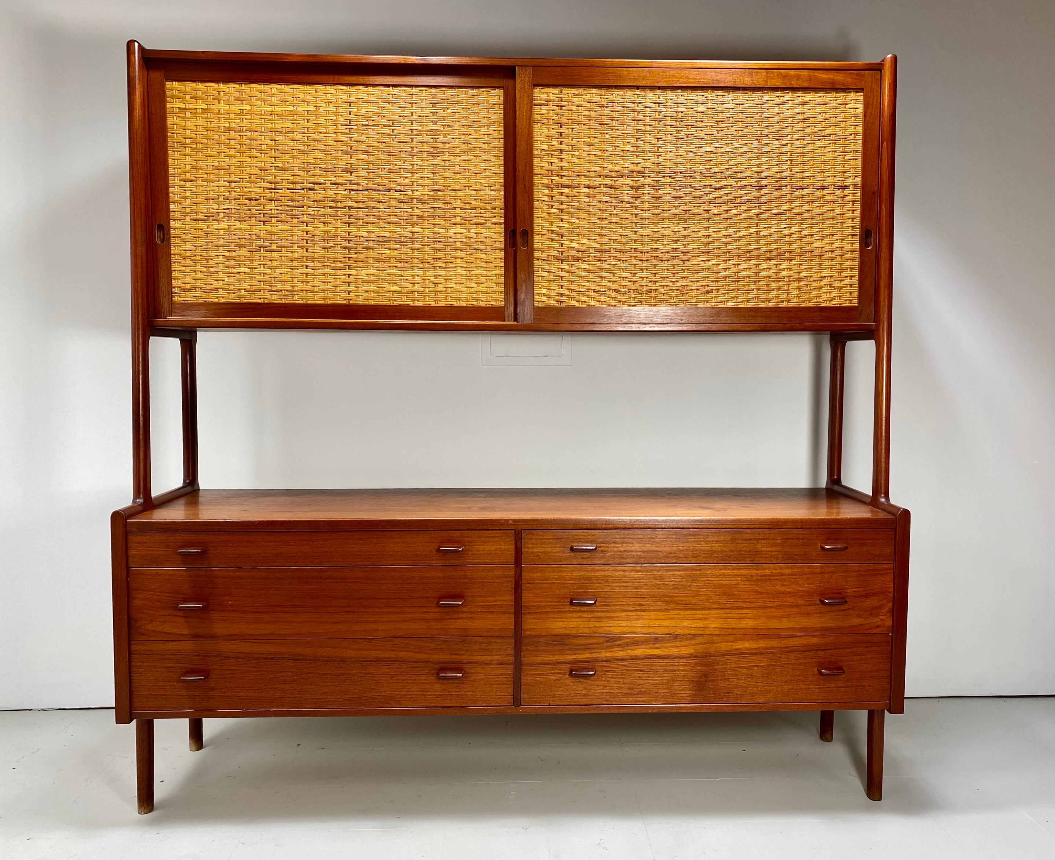 Hans Wegner teak sideboard for Ry Mobler. Model Ry-20. Cabinet has six drawers on the bottom and the top has sliding cane front doors concealing adjustable shelves. 1960s. Denmark

Delivery Available to NYC area for $475. Please inquire.
