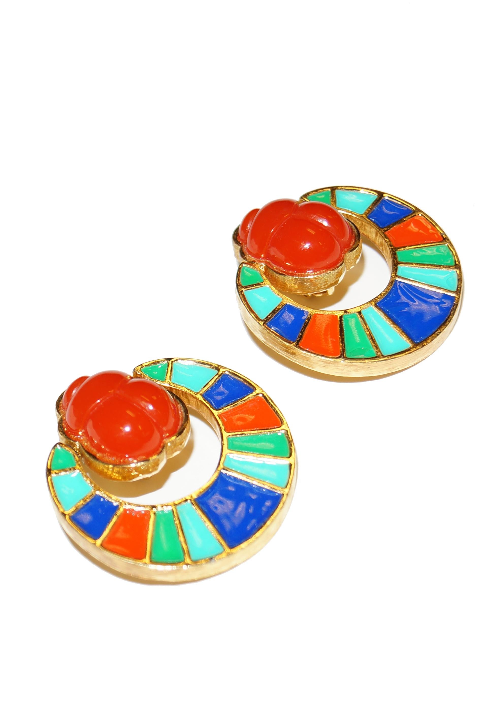 Astounding vivid blue, green, and orange enamel and acrylic earrings by Hattie Carnegie! This Egyptian Revival set of earrings feature a brilliant orange faux - carnelian scarab accented with a dangling moon - like enamel stripe semicircle. An