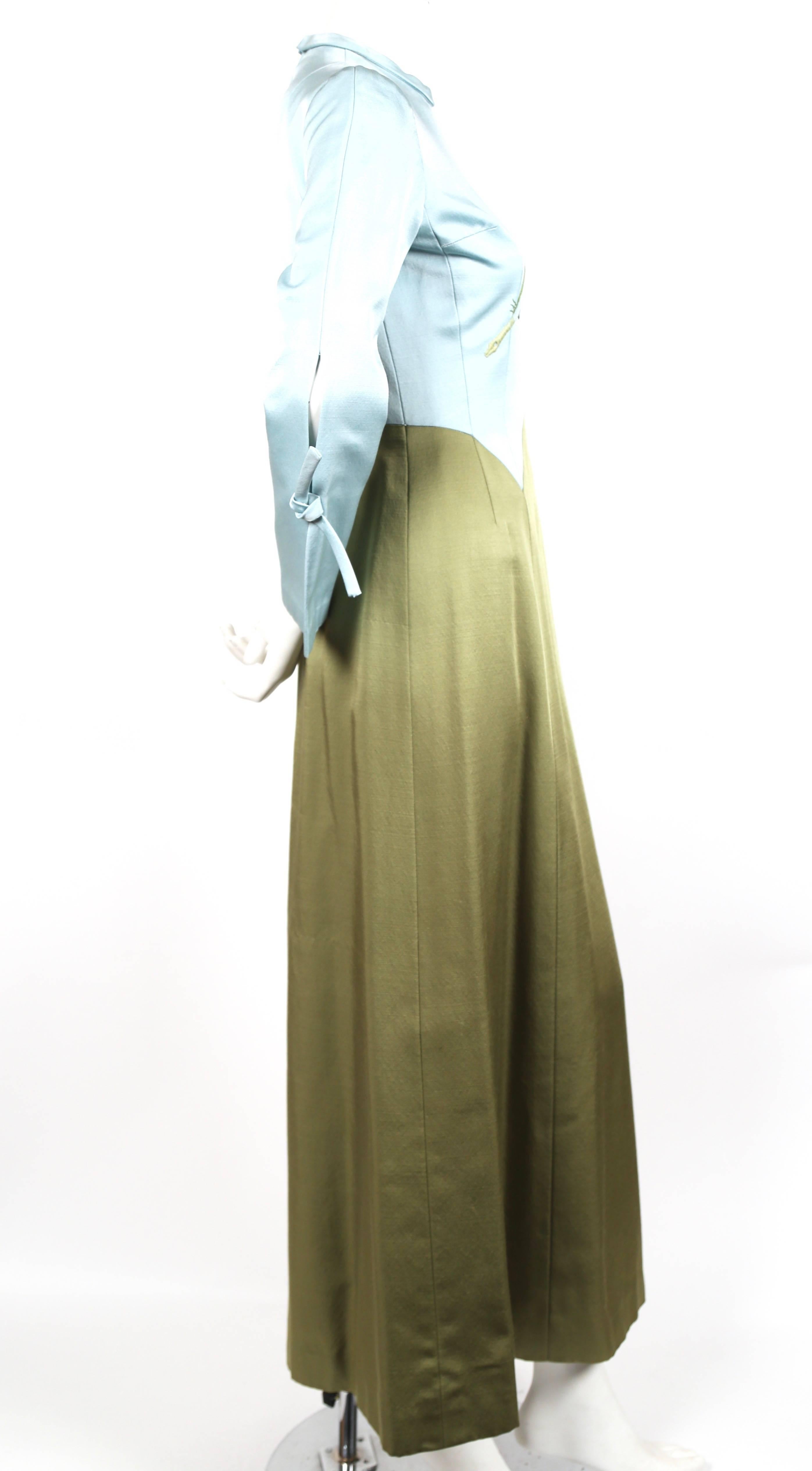 Ice blue and sage green haute couture gown made of silk with embroidered feather motif dating to the 1960's. Unique slits at forearms with decorative ties. Fits a US 2-4. Approximate measurements: shoulder 15