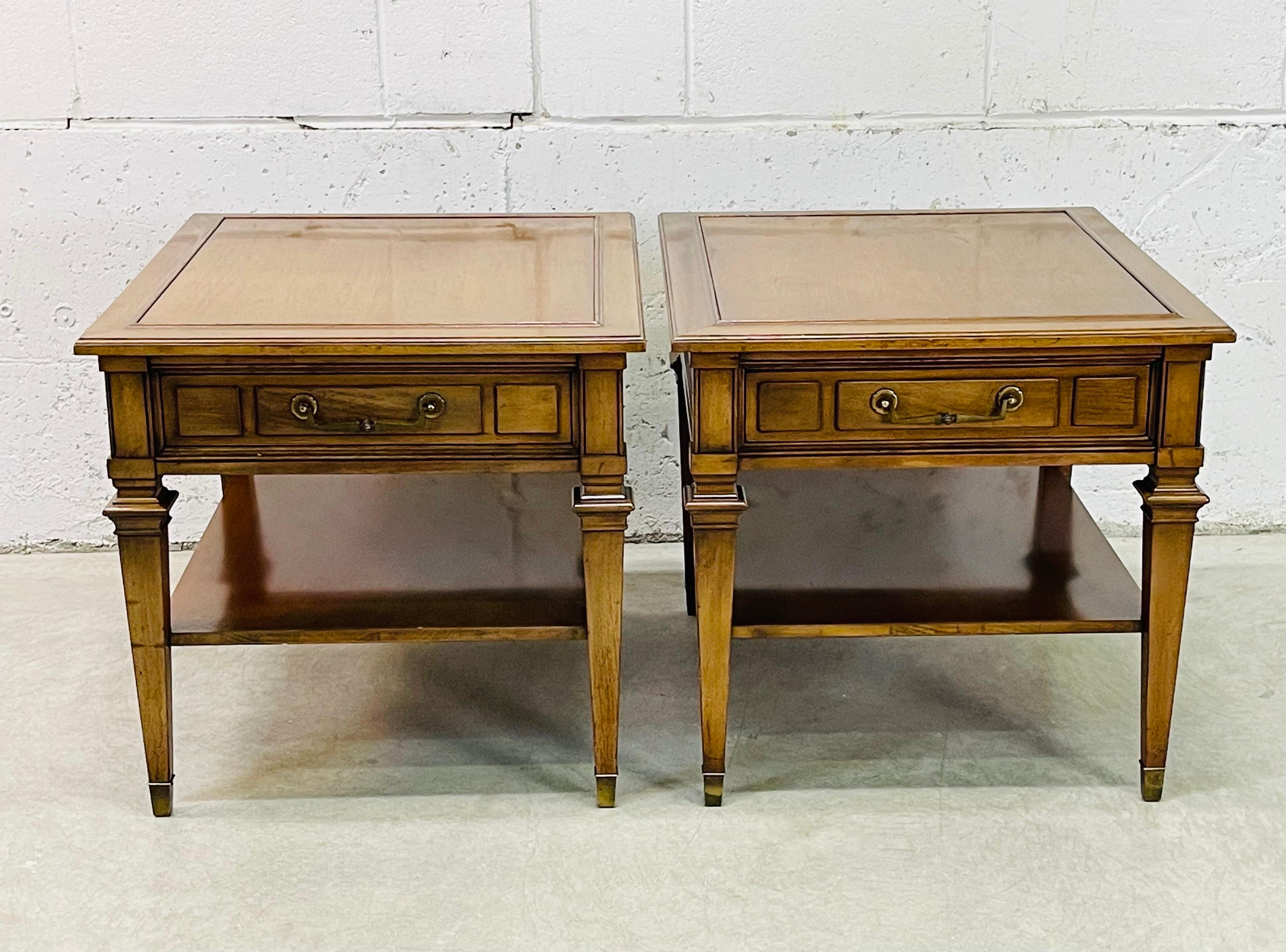Vintage 1960s pair of Hekman rectangular side tables with a single drawer for storage. Both tables also have an additional open shelf and brass pulls and accents. The shelf is 8”H. Marked in the drawer.